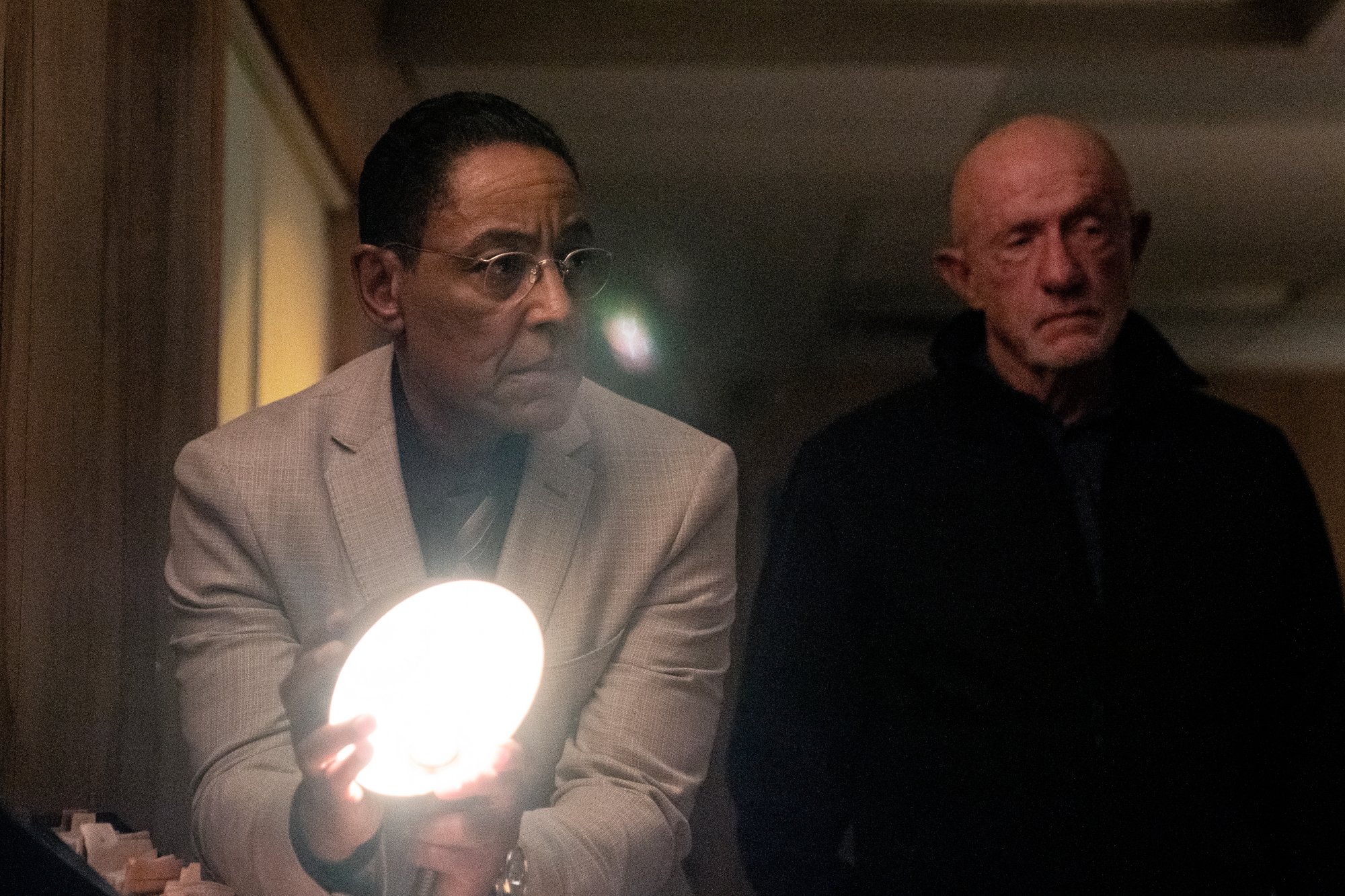 Giancarlo Esposito and Jonathan Banks as Gus and Mike in 'Better Call Saul' Season 6. Gus is holding a flashlight and they're looking at something.