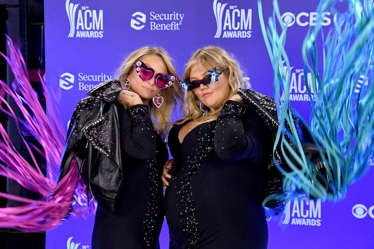 Miranda Lambert and Elle King pose for a picture in matching outfits and sunglasses