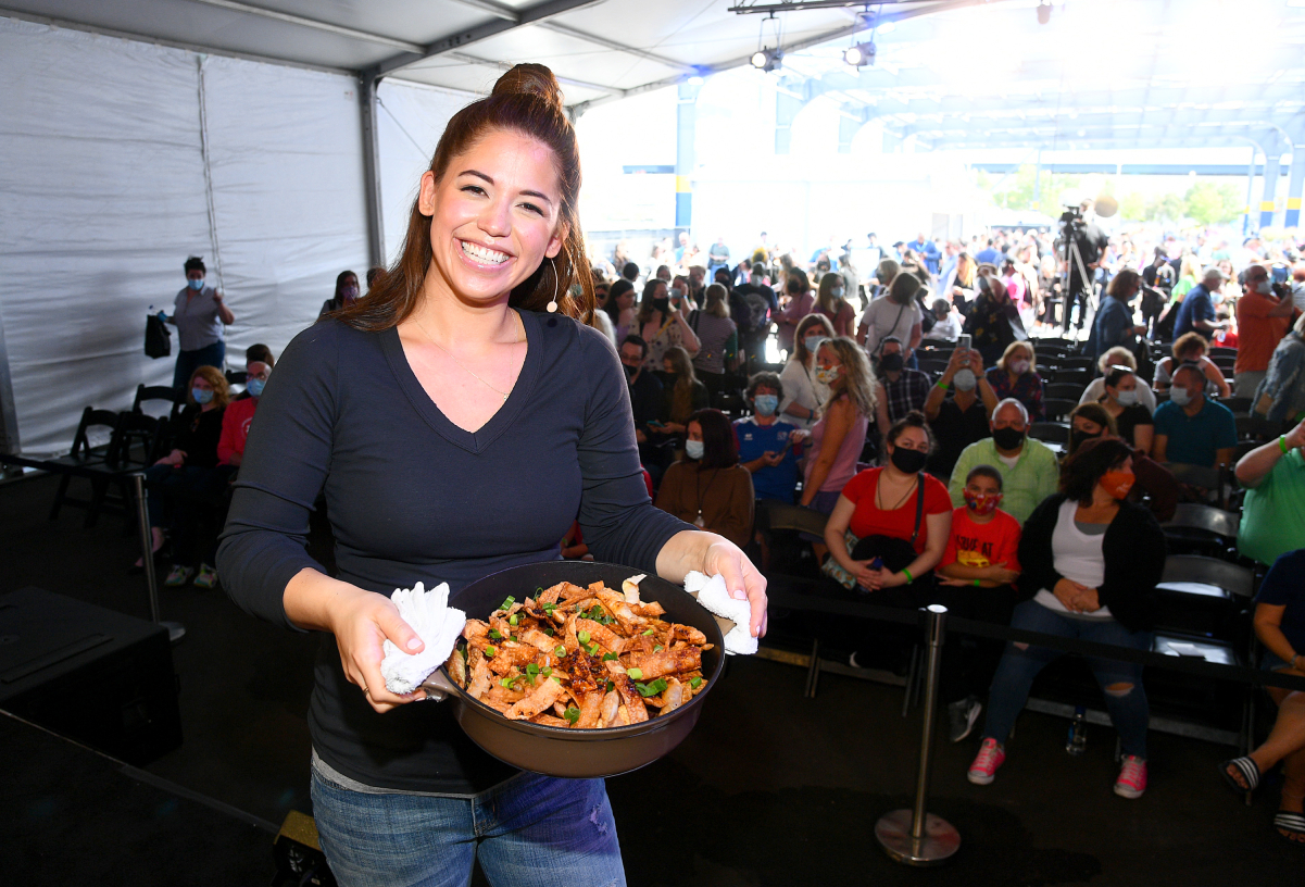 Food Network personality Molly Yeh wears a long-sleeved black top in this photograph.