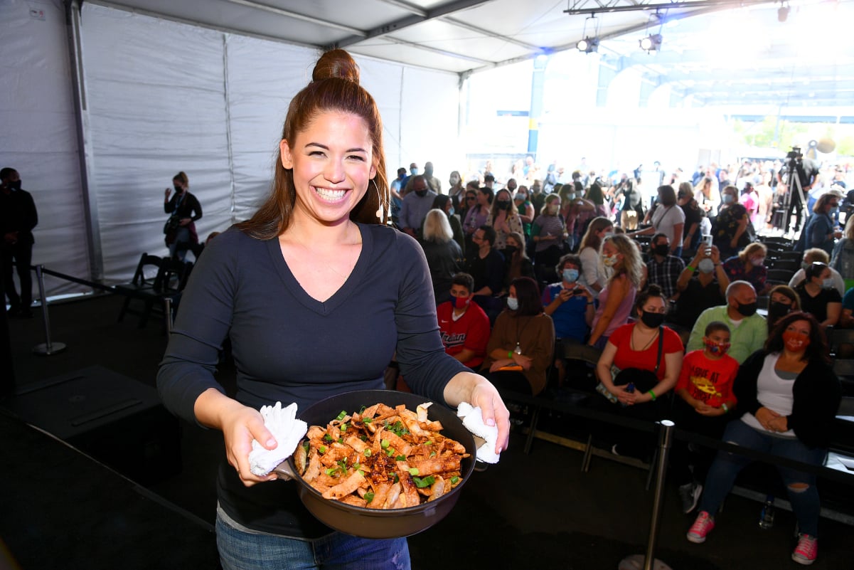 Food Network personality Molly Yeh wears a long-sleeved navy blue top in this photograph.