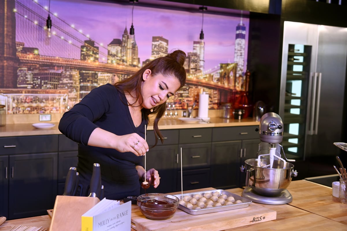 Food Network personality Molly Yeh wears a long-sleeved black top in this photograph.