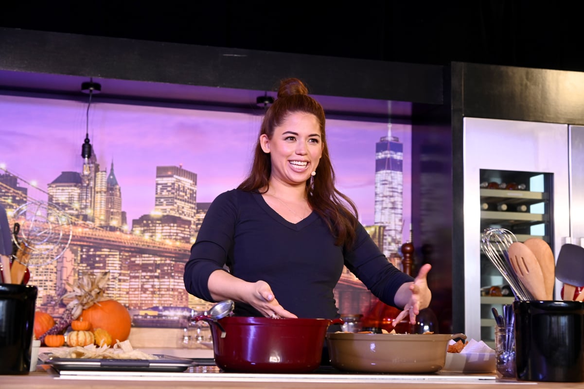 Food Network personality Molly Yeh wears a long-sleeved sweater in this photograph.