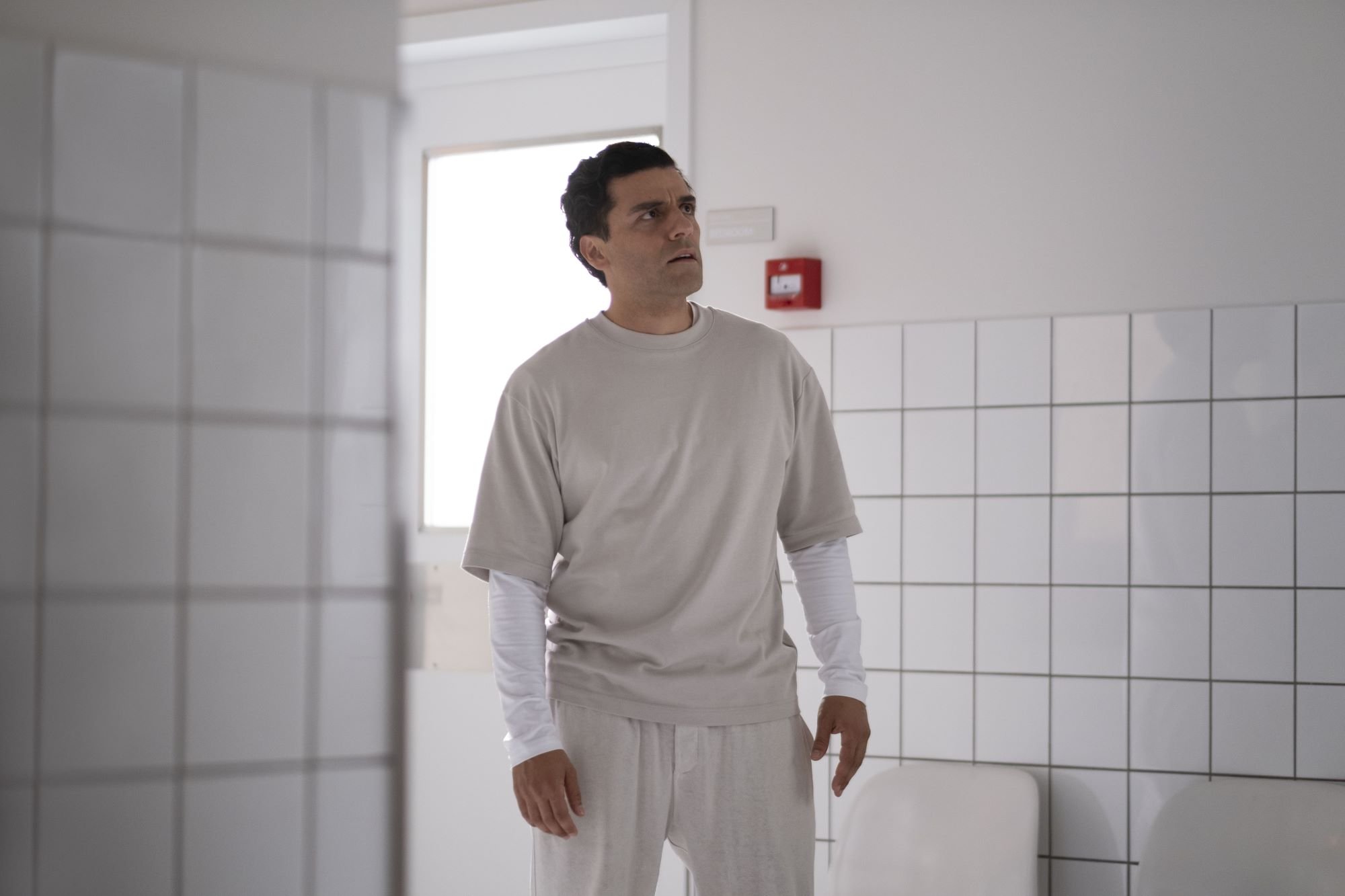 Oscar Isaac, who plays Marc Spector in the 'Moon Knight' finale, wears a short-sleeved white shirt over a long-sleeved white shirt and white pants.