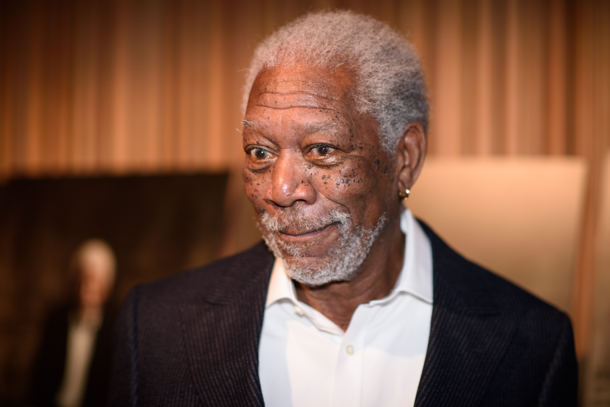 Morgan Freeman, the man with an iconic voice, wearing a suit
