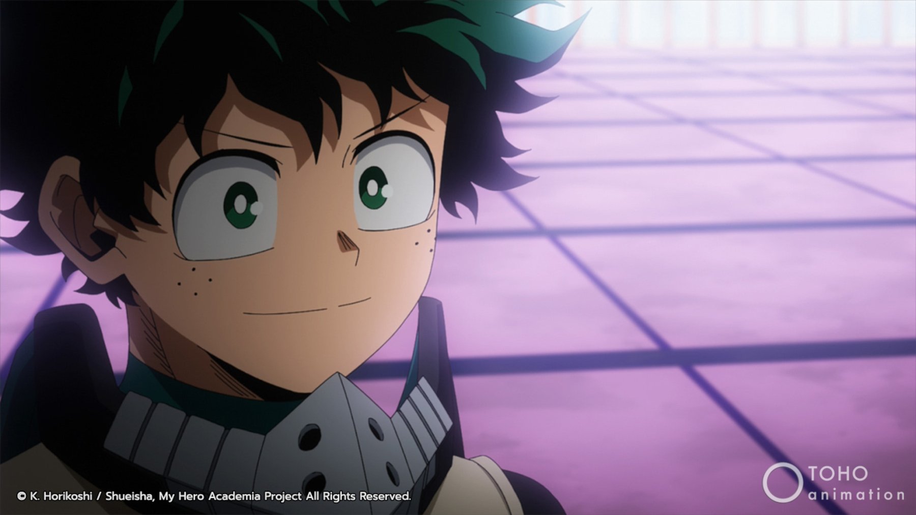 Deku in 'My Hero Academia' Season 5. He's standing in front of purple tiles and smiling.