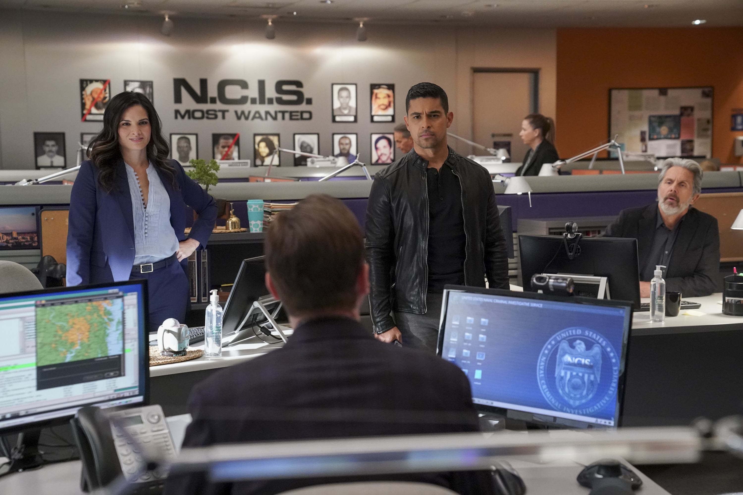 The NCIS cast meets in the office.
