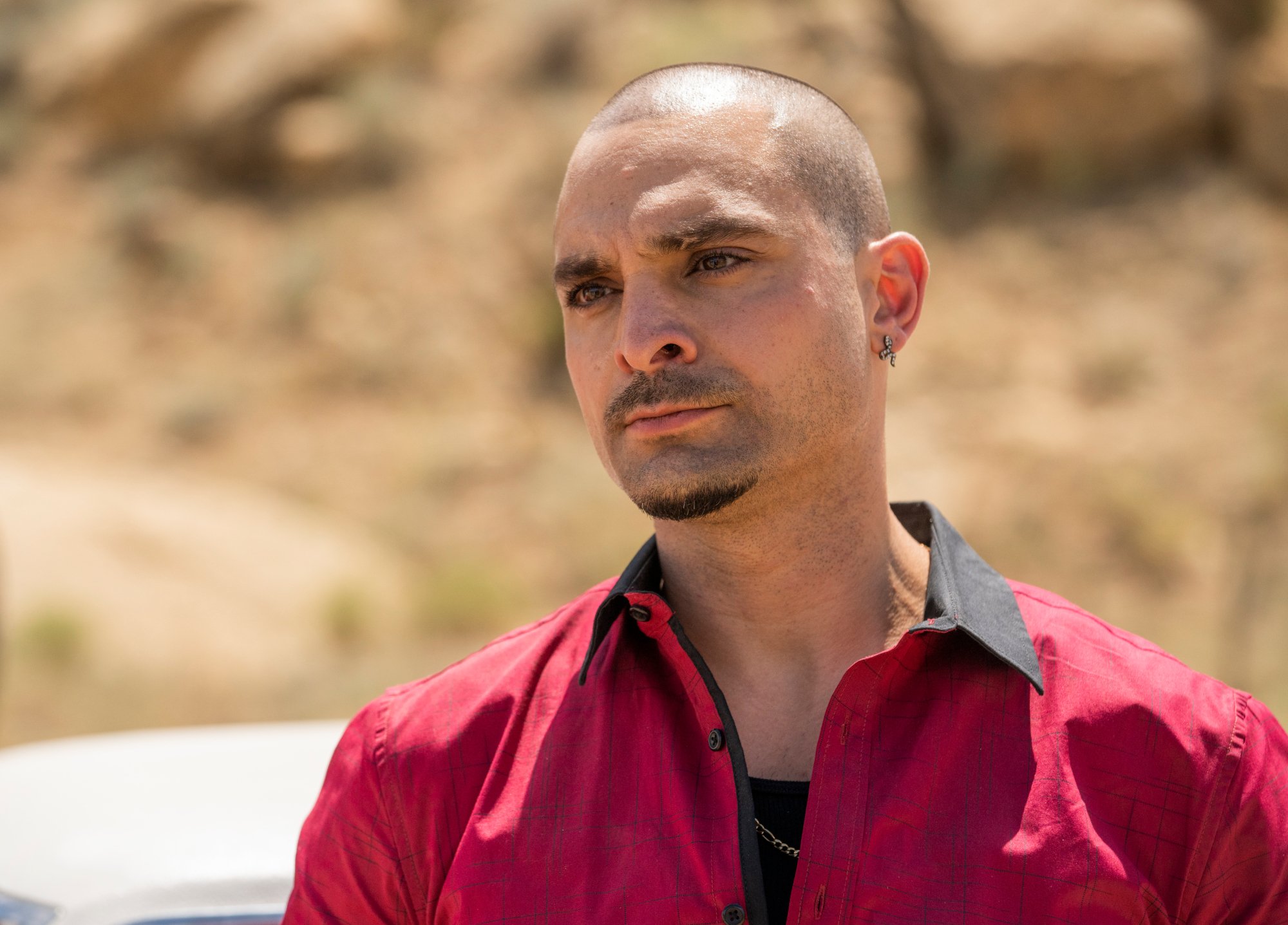 Michael Mando as Nacho Varga in 'Better Call Saul' Season 5. He's wearing a red shirt.