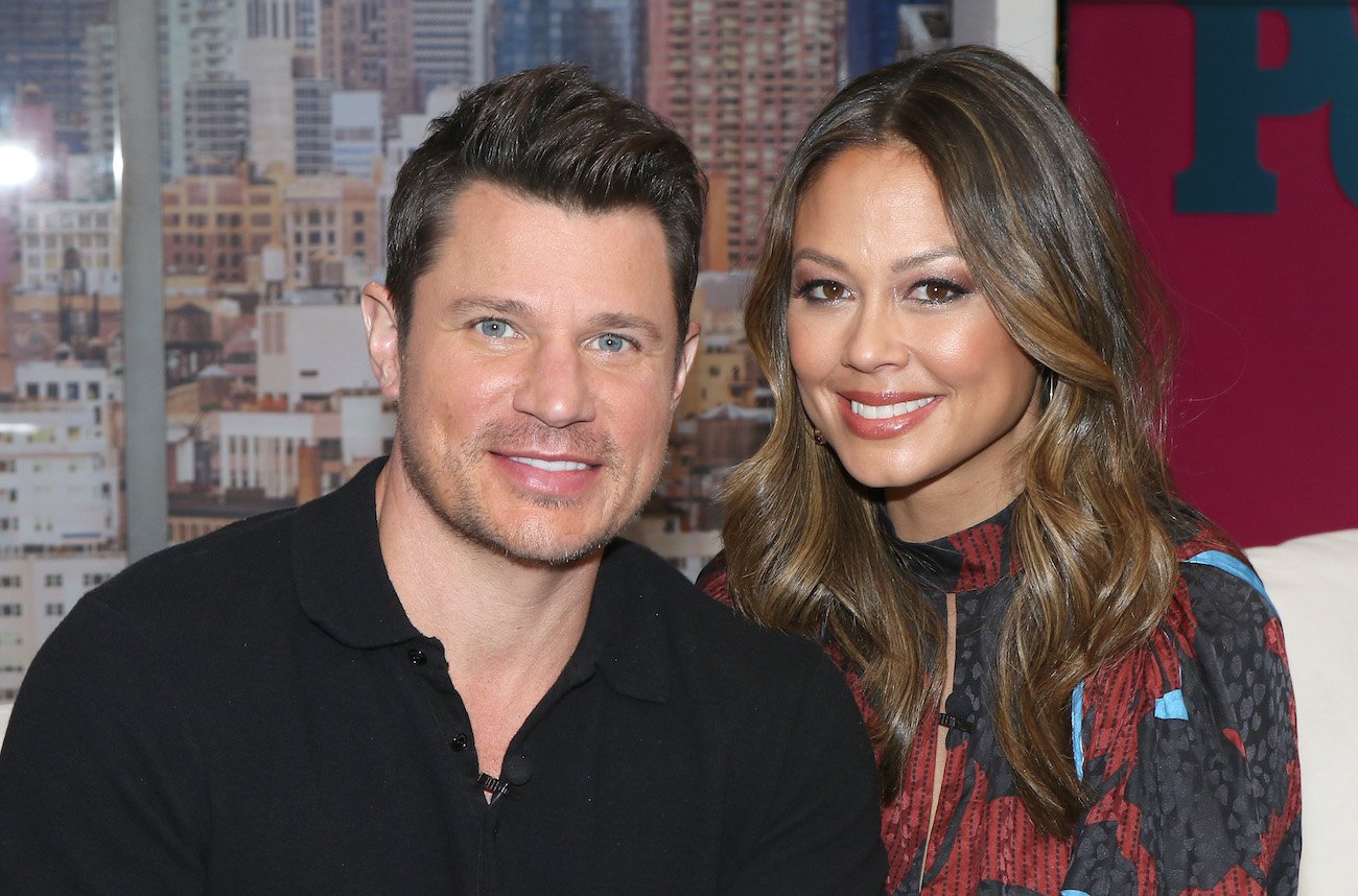 Nick Lachey and Vanessa Lachey situated next to each other and smiling at the camera
