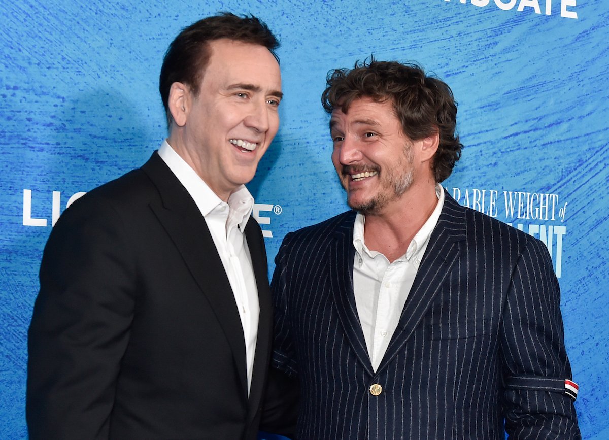 Nicolas Cage and Pedro Pascal smile at each other at the LA special screening of "The Unbearable Weight of Massive Talent"