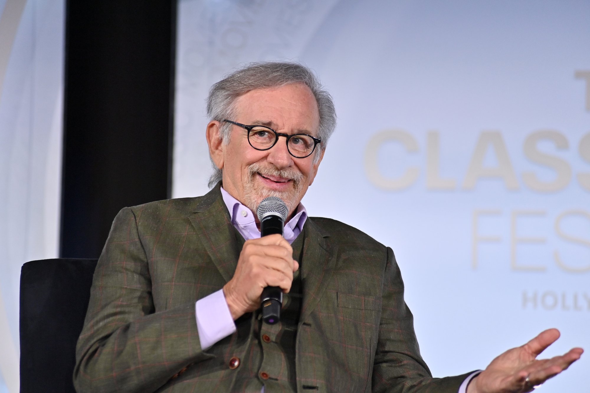 'Night Gallery' director Steven Spielberg talking about Joan Crawford holding a microphone and wearing a suit in front of a Turner Classic Movie Movies graphic