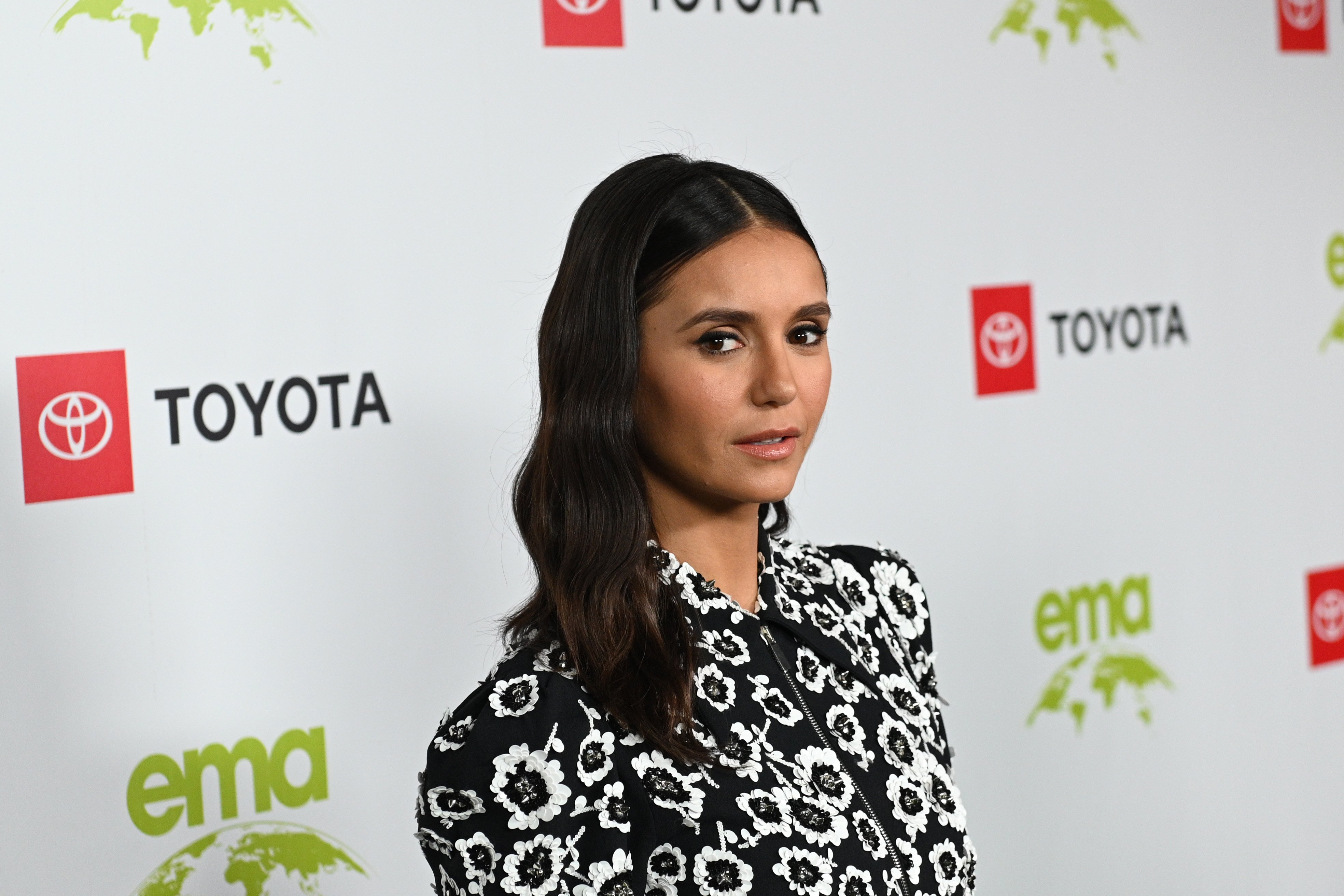 Nina Dobrev, who played Elena in 'The Vampire Diaries,' wears a black and white floral dress.