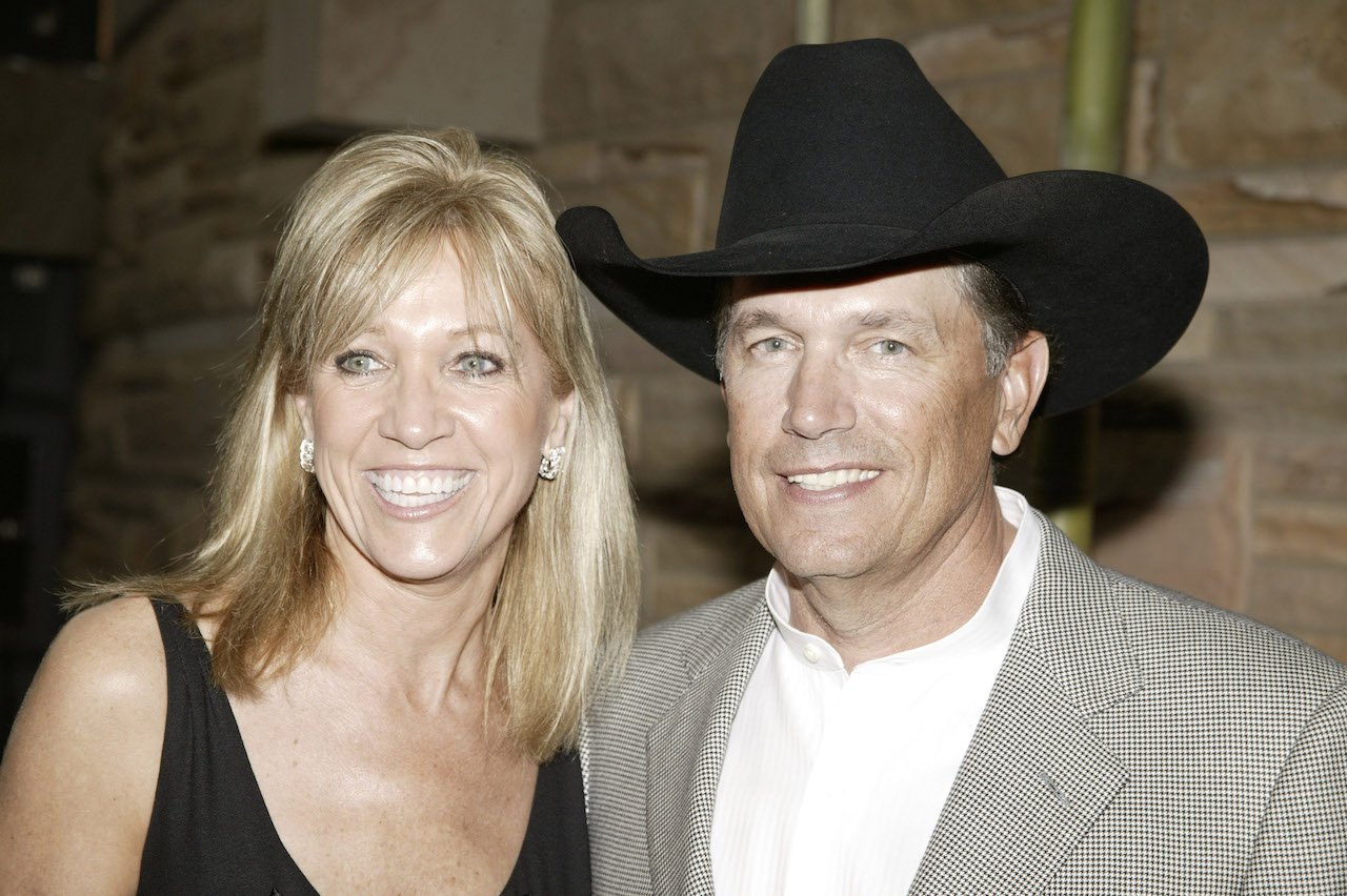 George Strait in a cowboy hat and his wife Norma smile for a picture during the 2007 Country Music Hall of Fame Medallion Ceremony