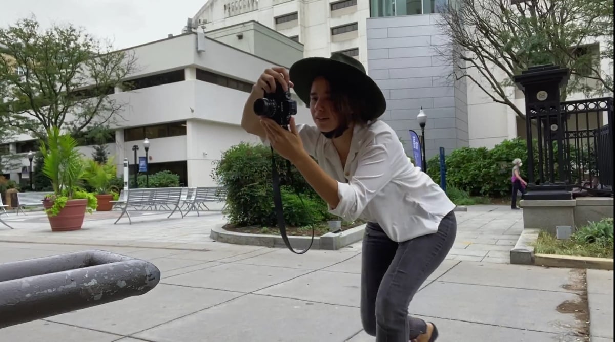 Olga Koshimbetova taking photos with her camera in DC on '90 Day Diaries' Season 3.