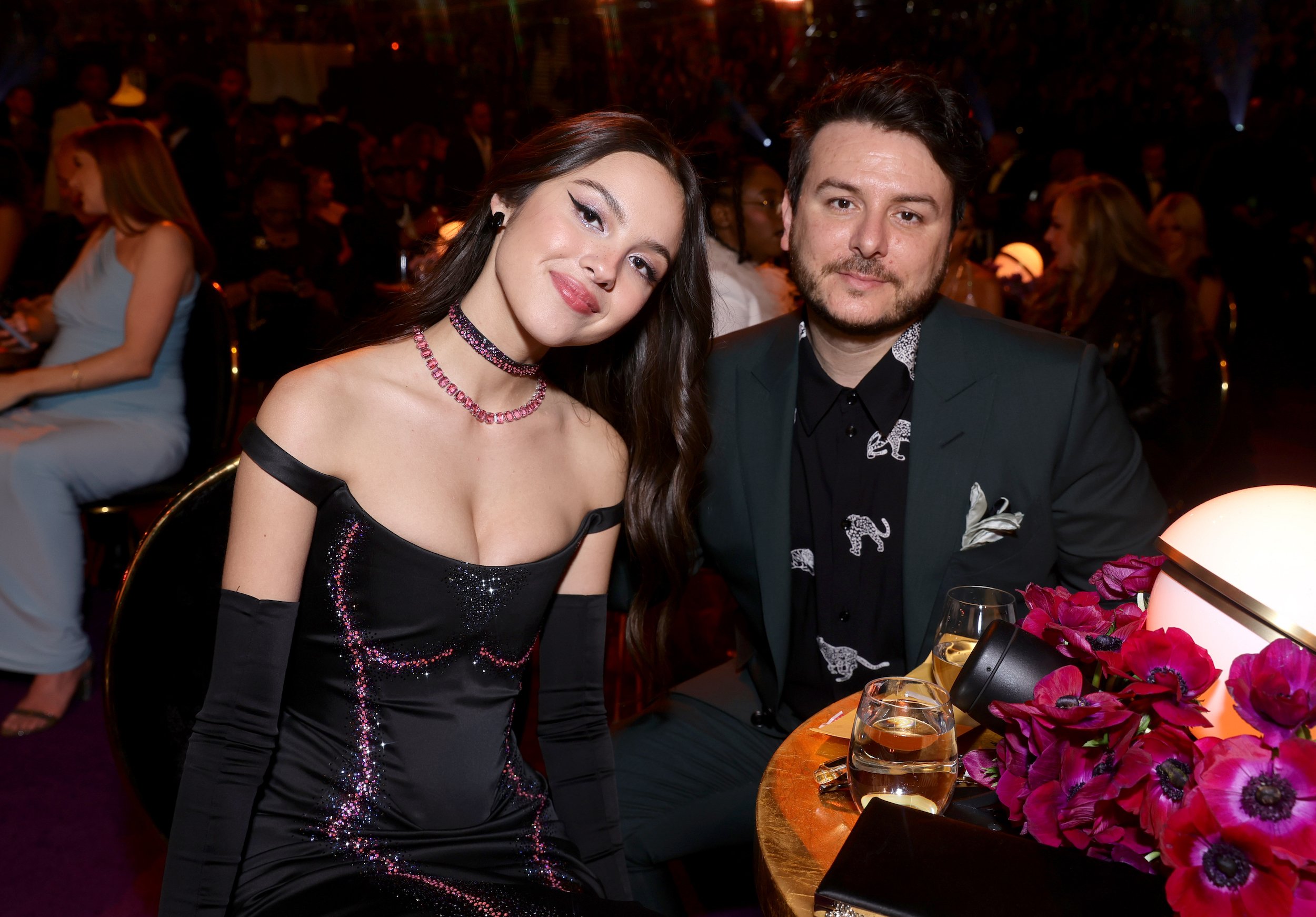 Olivia Rodrigo and Dan Nigro sitting at the 64th Annual GRAMMY Awards