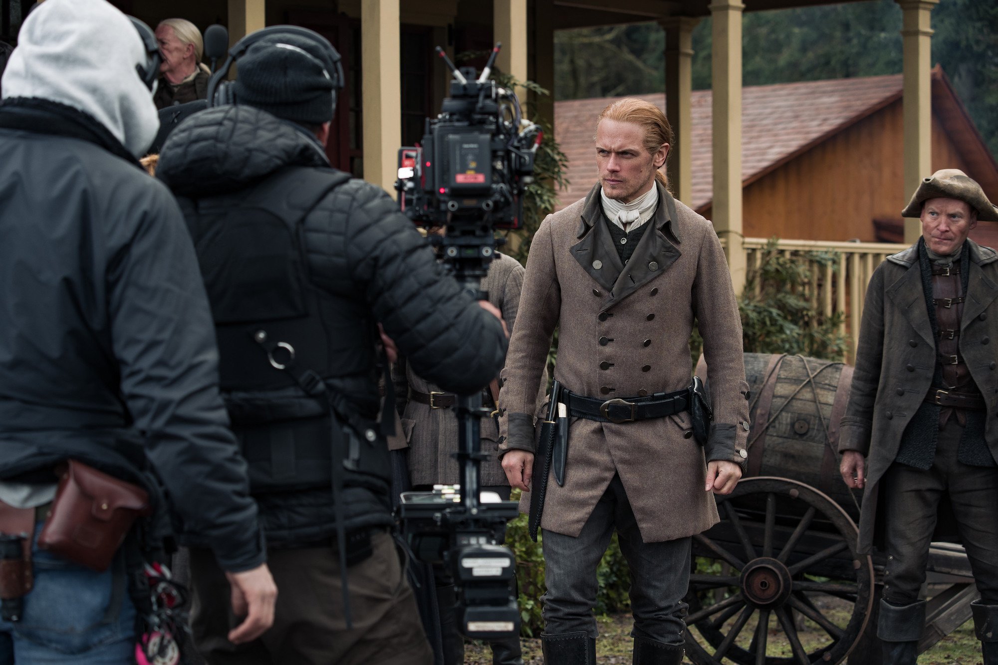 'Outlander': Sma Heughan stands in front of the camera crew in costume