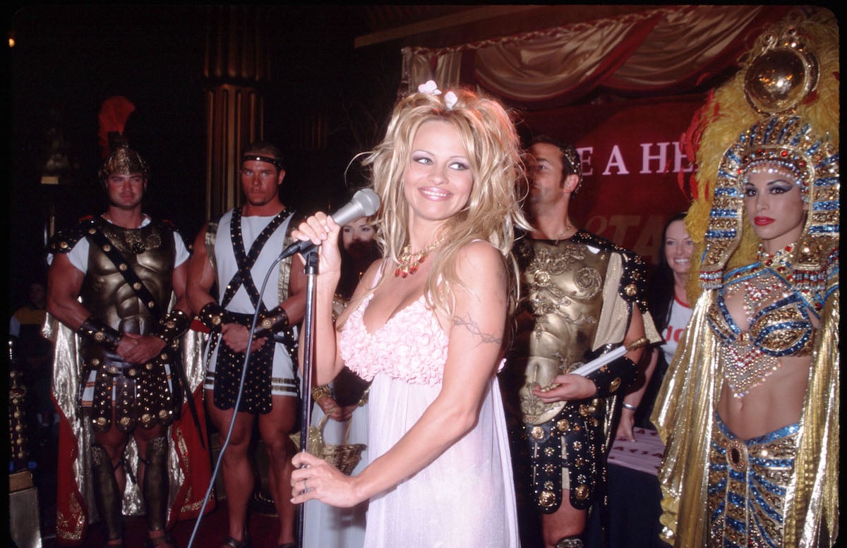 TV star Pamela Anderson Lee holds a microphone during a 1999 PETA event
