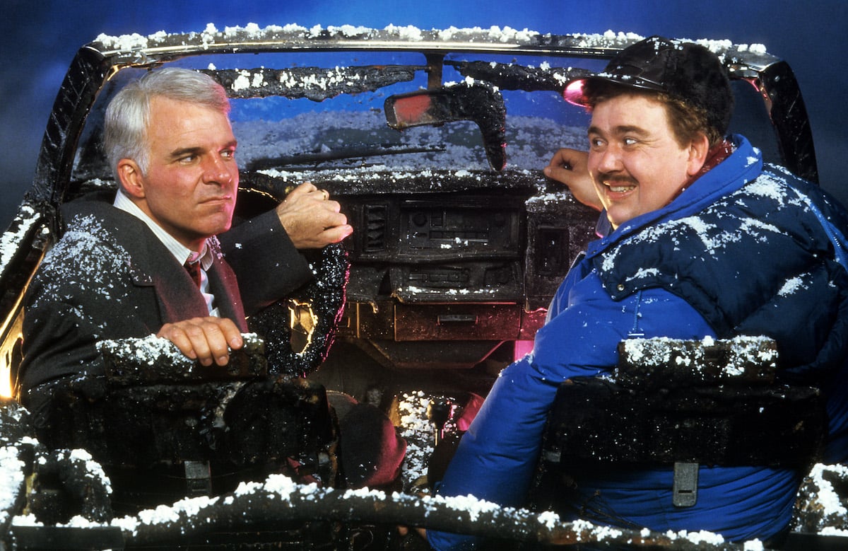 Steve Martin and John Candy sit in a destroyed car in 'Planes, Trains & Automobiles'