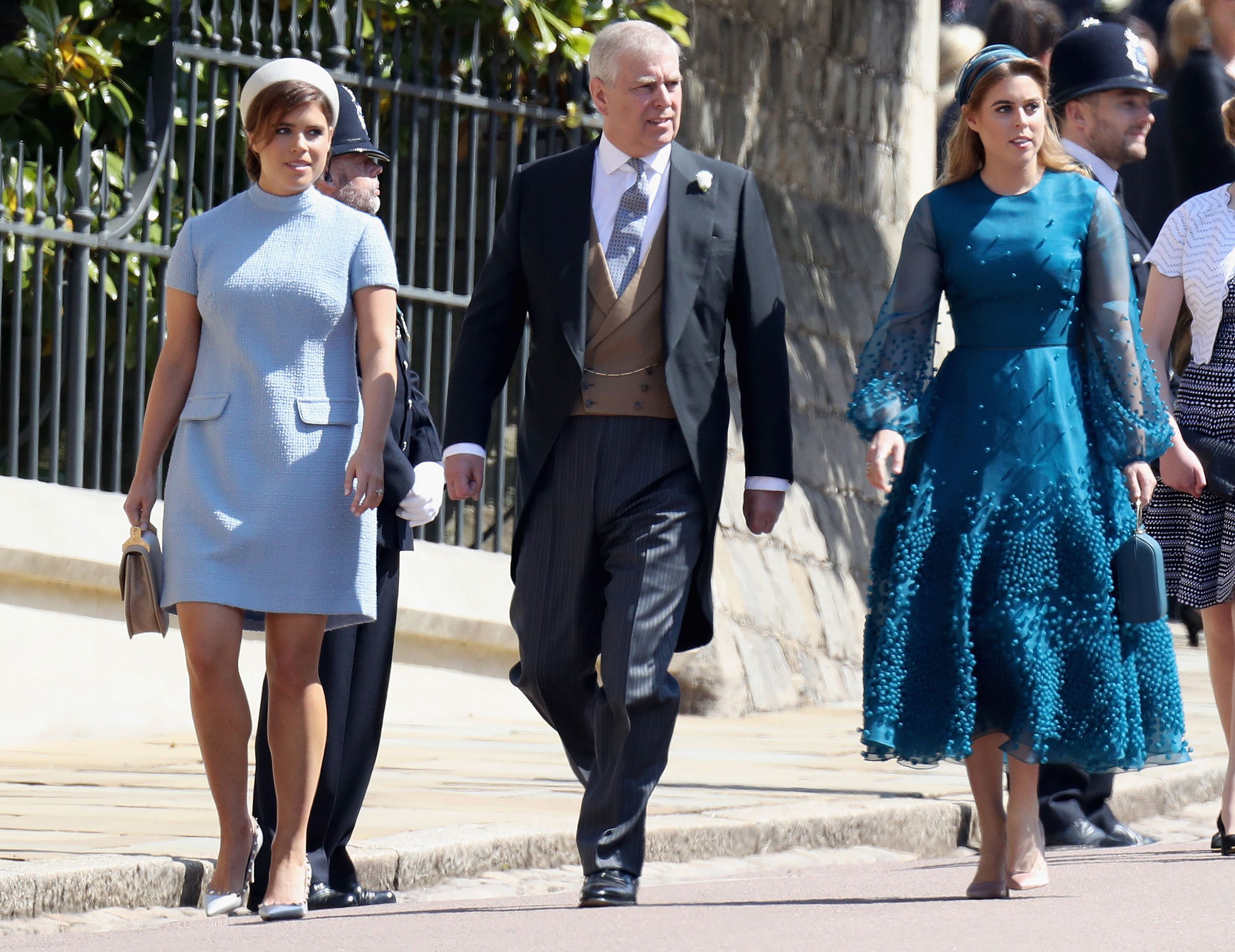 Prince Andrew with his daughters Princess Eugenie and Princess Beatrice, who are now caught up in his fraud case, arriving to the wedding of Prince Harry and Meghan Markle