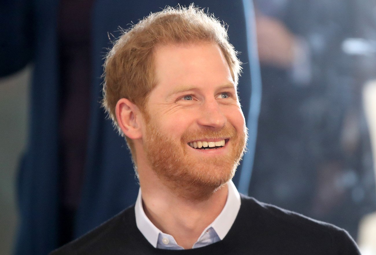 Prince Harry smiling and looking up