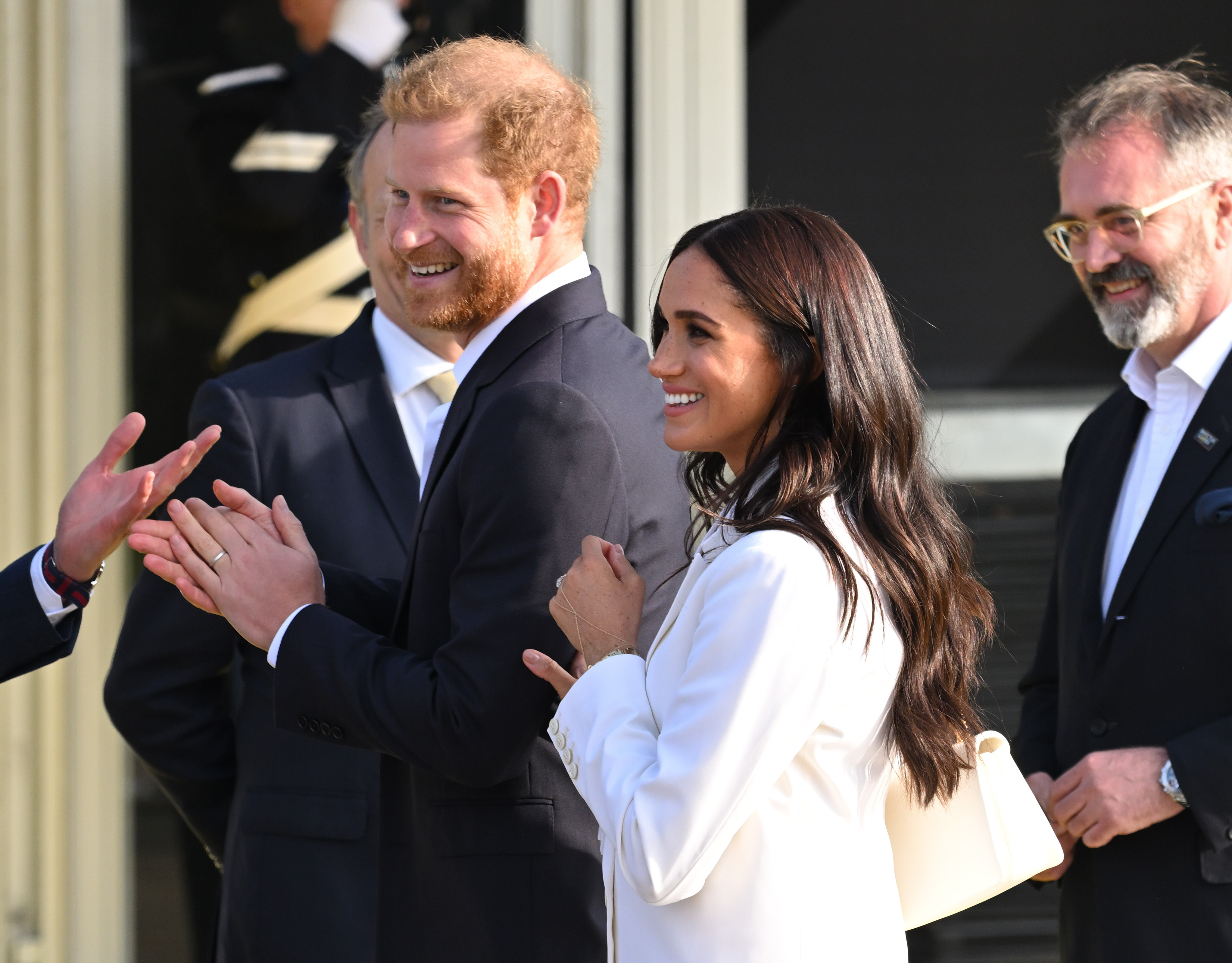 Prince Harry and Meghan Markle smile as they arrive at the Invictus Games in The Hague, Netherlands