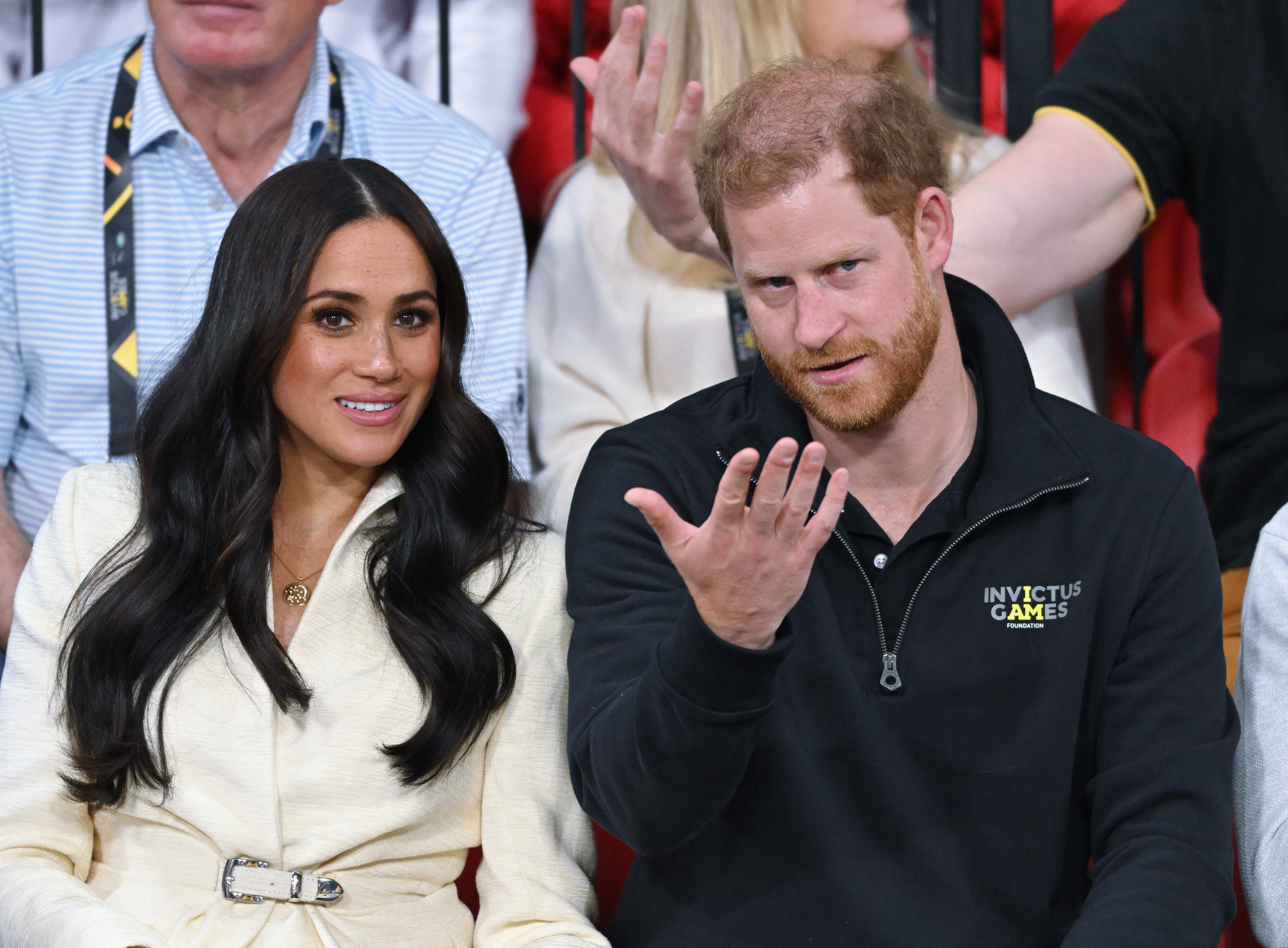 Prince Harry and Meghan Markle sitting during a volleyball event at the Invictus Games