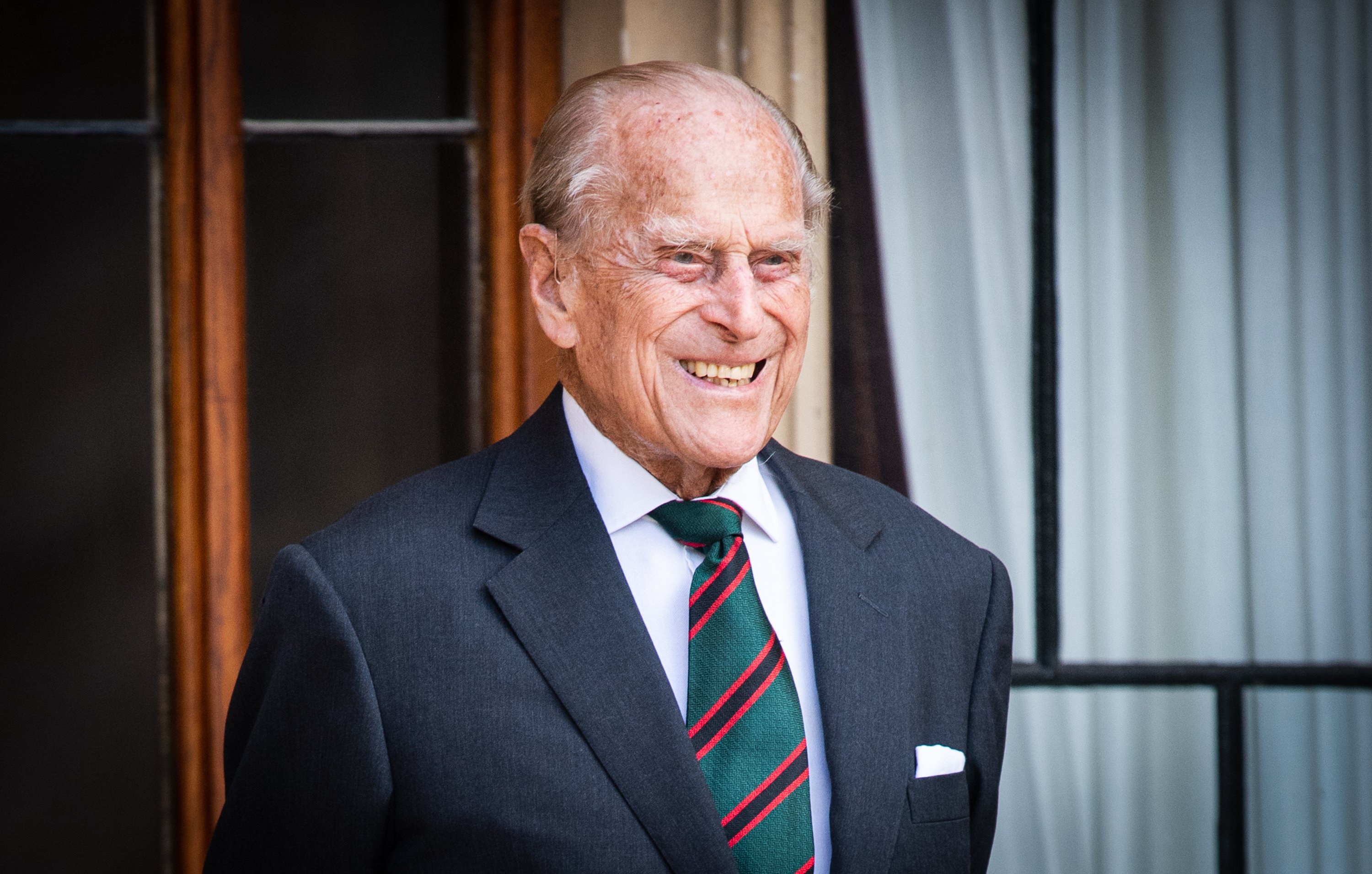 Prince Philip, who arranged a photographer to hide at his funeral, smiling during the transfer of the Colonel-in-Chief of The Rifles