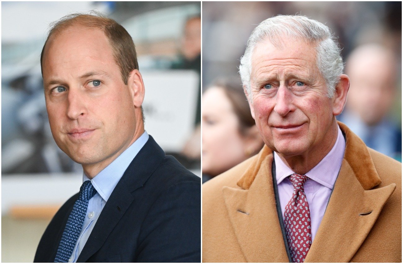Prince William looking to the right of the camera in a suit, Prince Charles looking on while wearing a brown jacket
