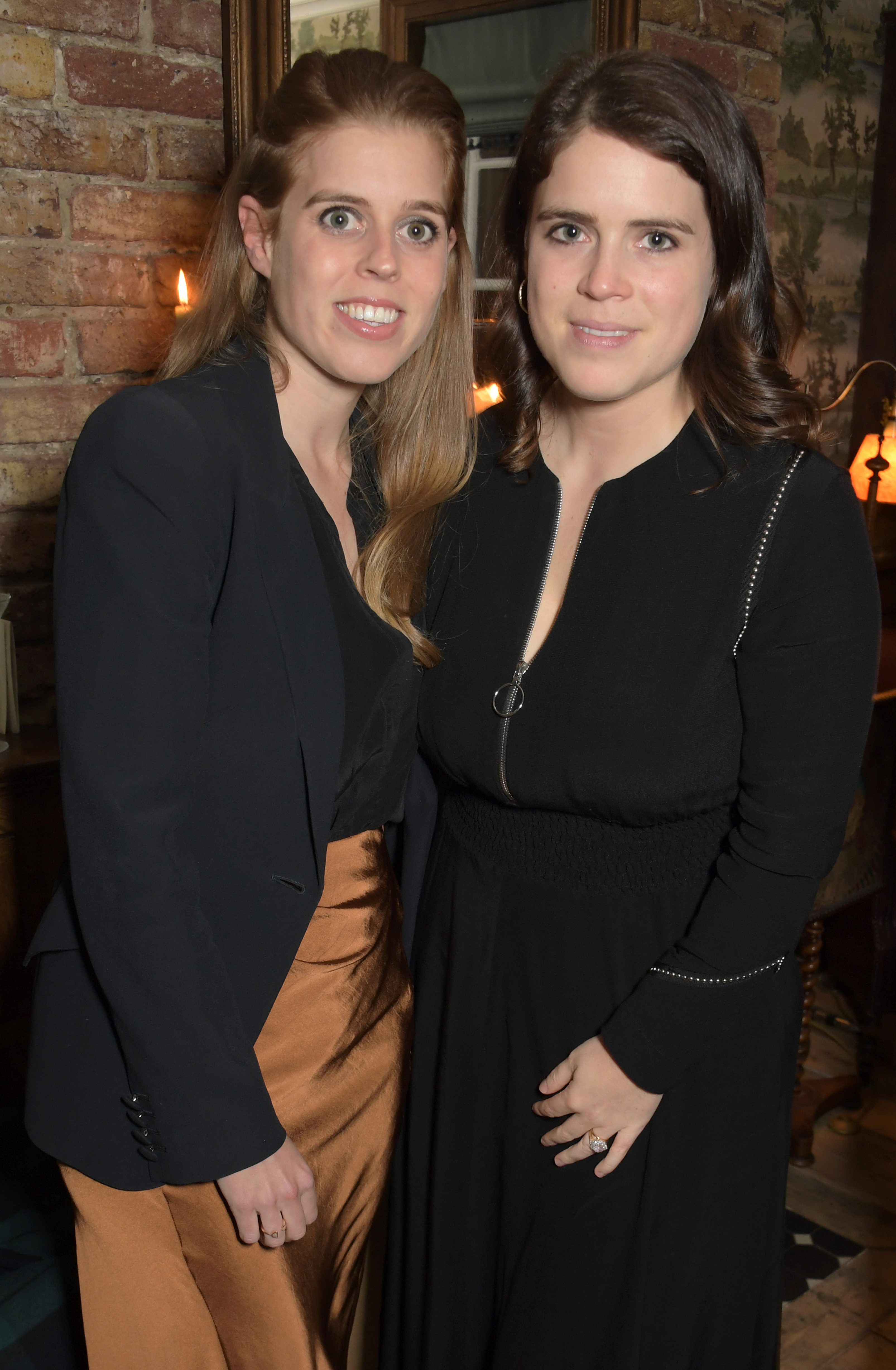 Princess Beatrice and Princess Eugenie pose for a photo together at a dinner party in London
