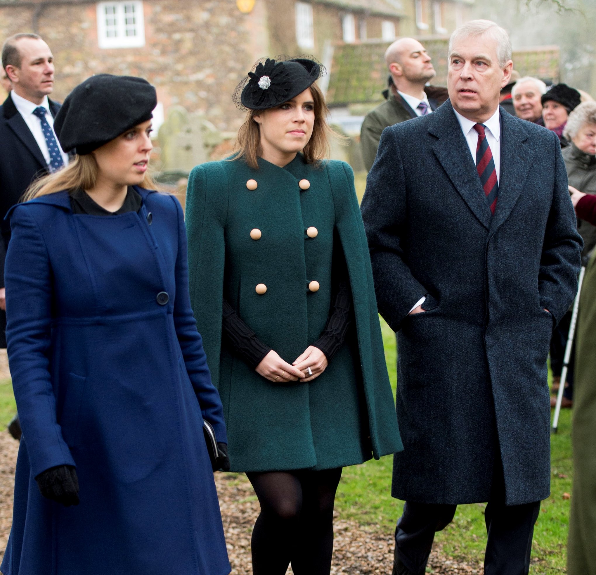 Princess Eugenie and Princess Beatrice standing with their father, Prince Andrew, at St. Lawrence Church in Sandringham