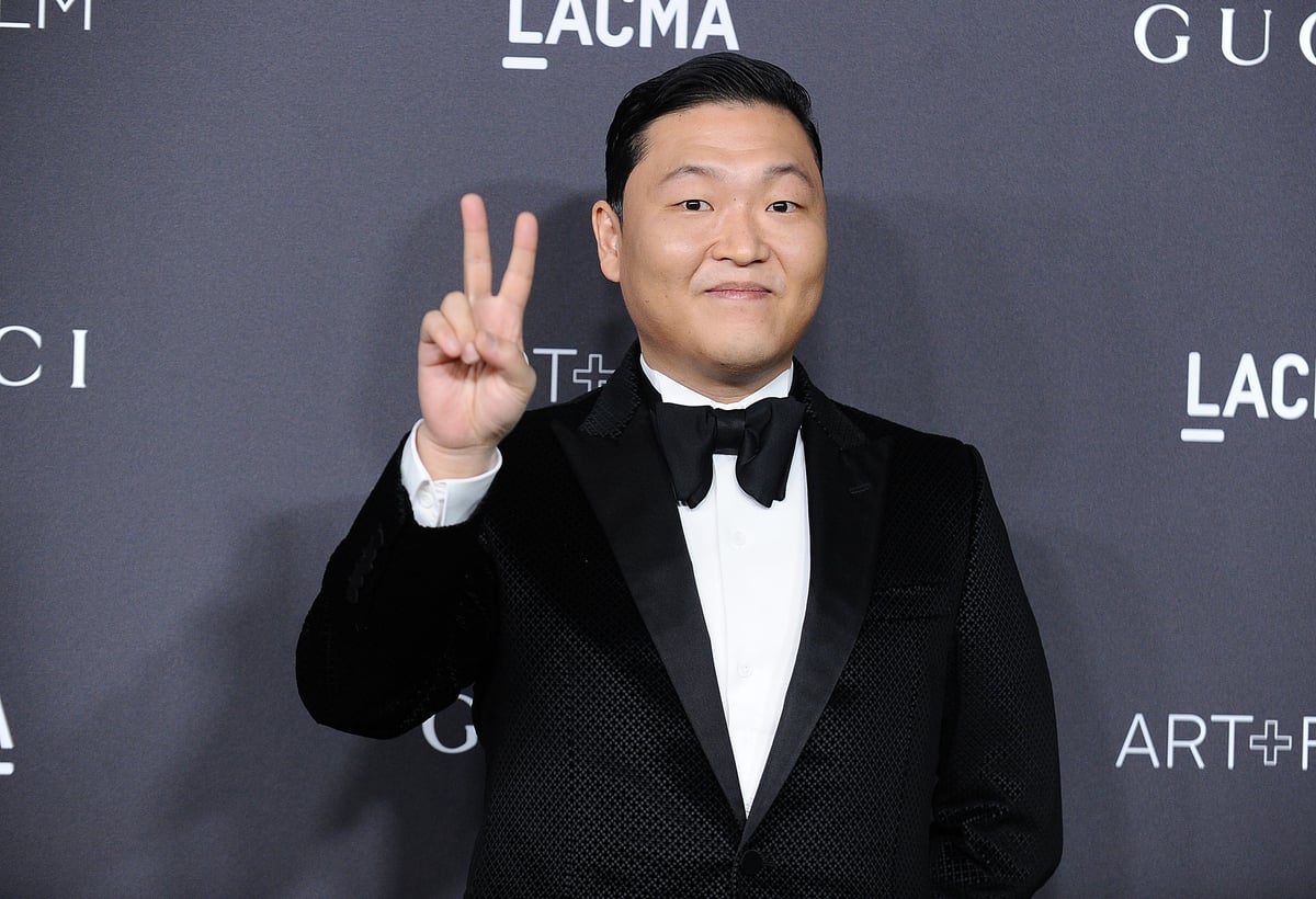 Flashing a peace sign and wearing a black tuxedo, Psy attends the LACMA art and film gala in LA.