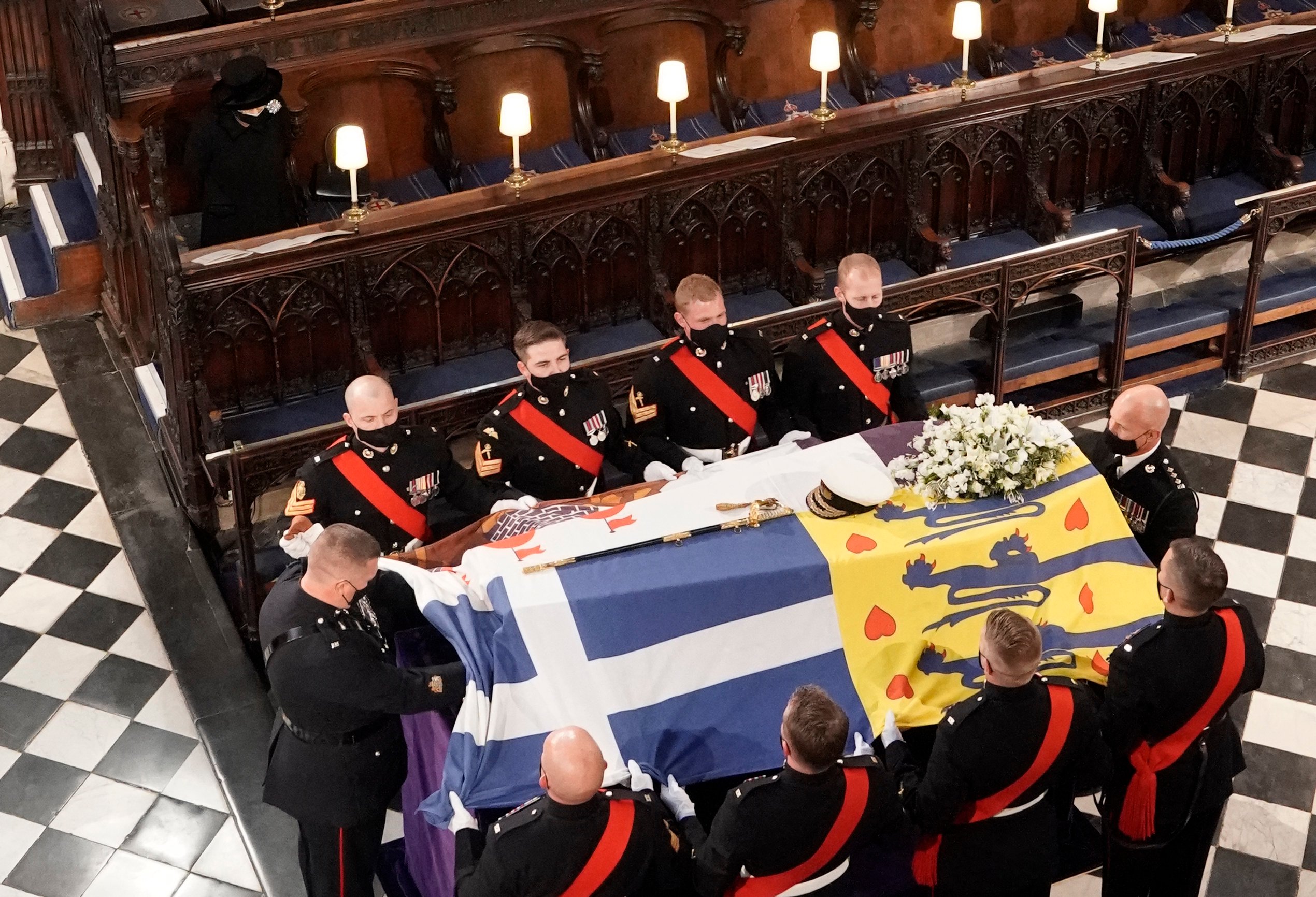 Queen Elizabeth II watches as pallbearers carry the coffin of Prince Philip during his funeral