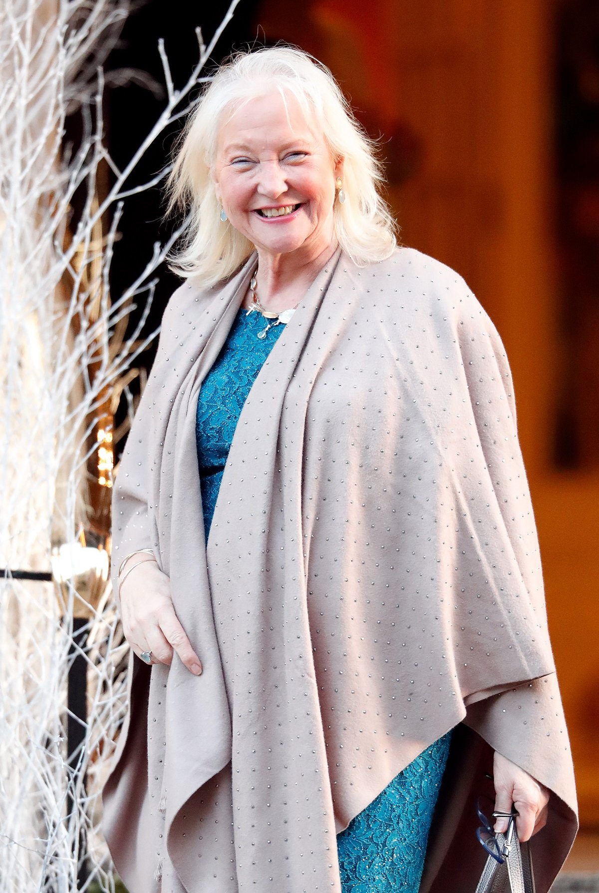 Queen Elizabeth II's personal assistant and dressmaker Angela Kelly smiling outside a store