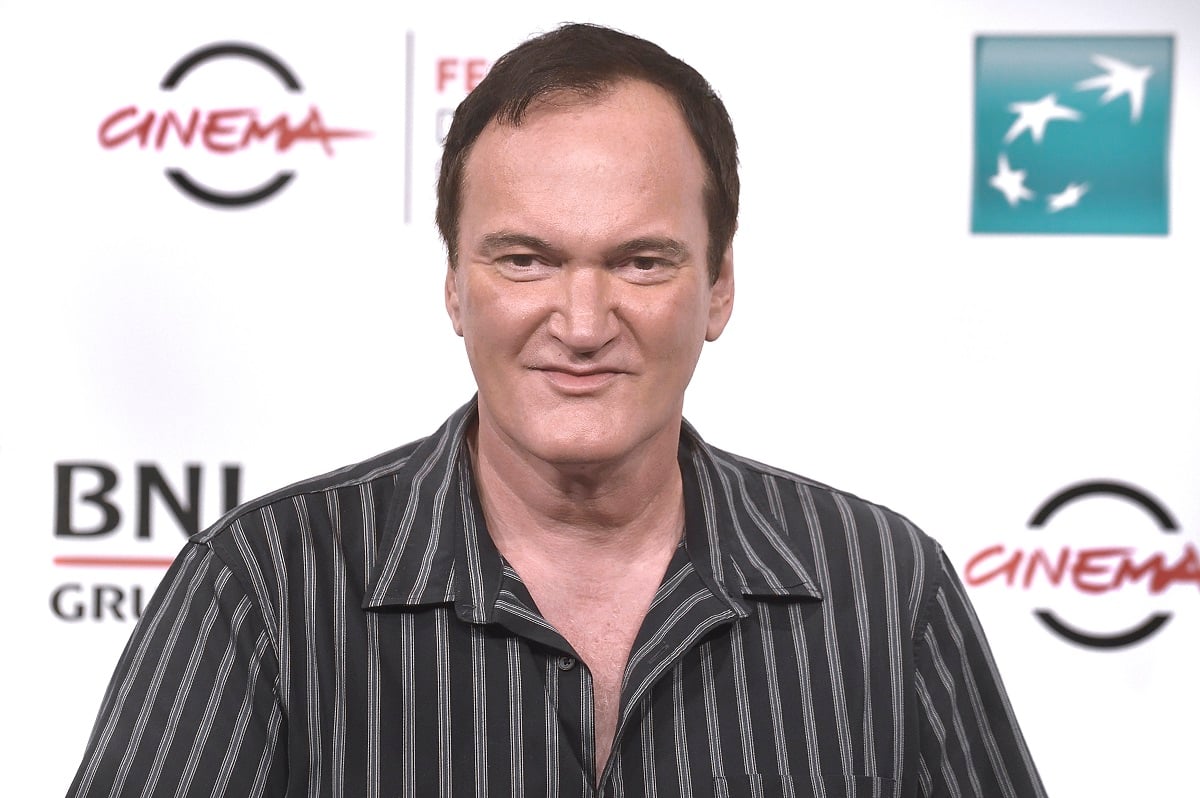 Quentin Tarantino smirking while wearing a black shirt.