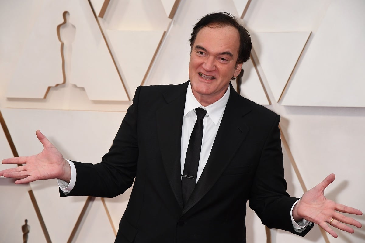 Quentin Tarantino posing while wearing a suit.