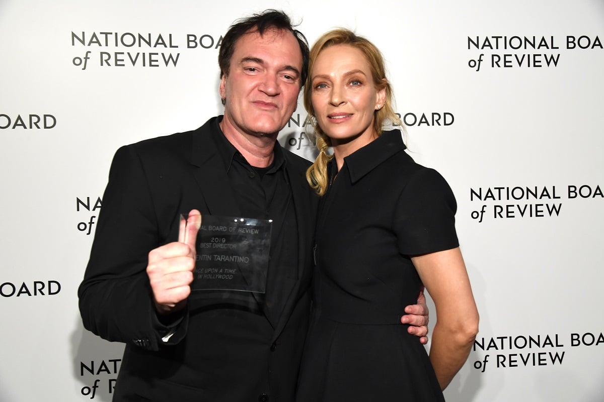 Quentin Tarantino smiling alongside Uma Thurman.