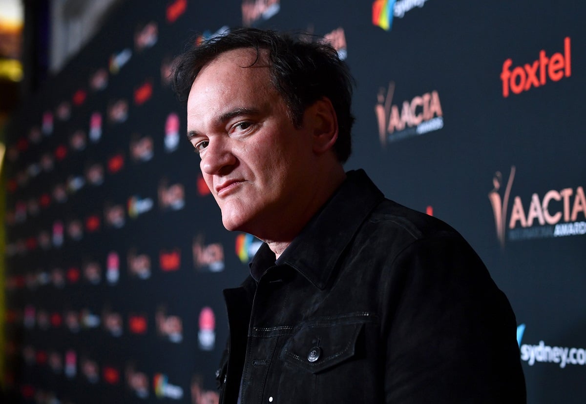 Quentin Tarantino posing while wearing a black jacket.