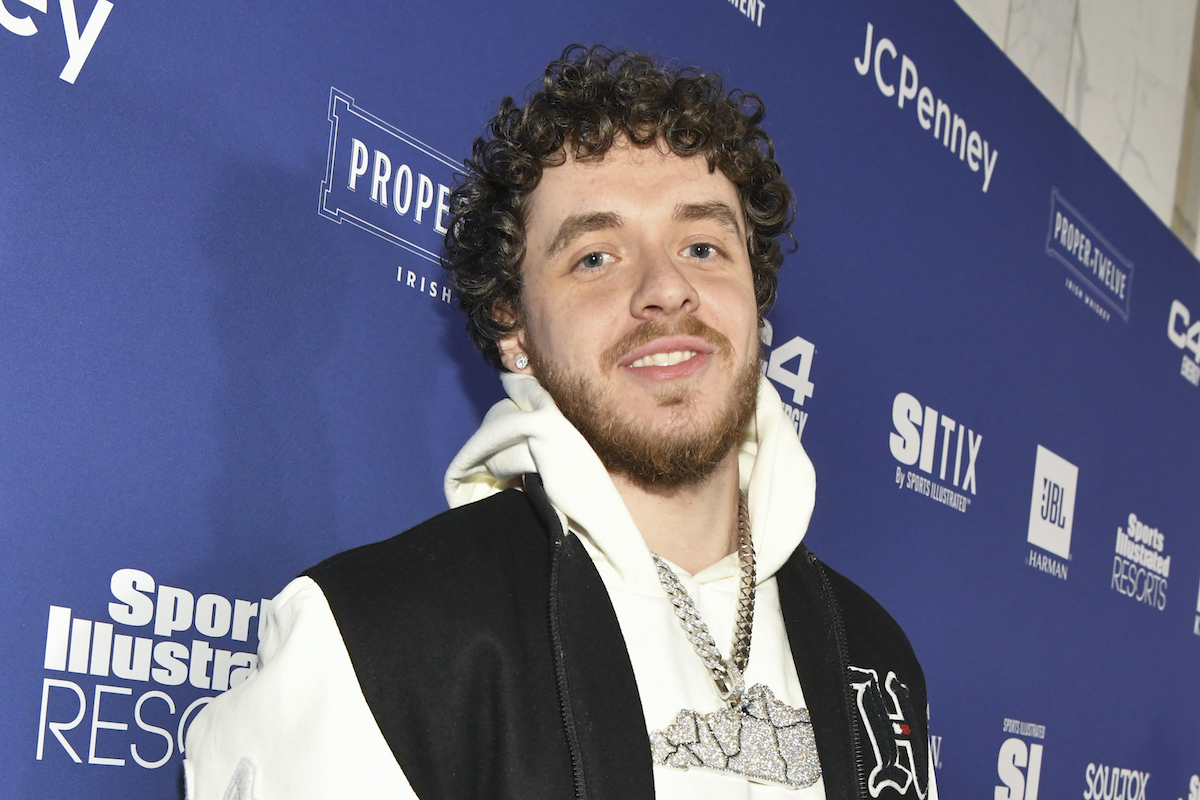 'First Class' rapper Jack Harlow smiles wearing a white sweatshirt at the 2022 Sports Illustrated Super Bowl Party