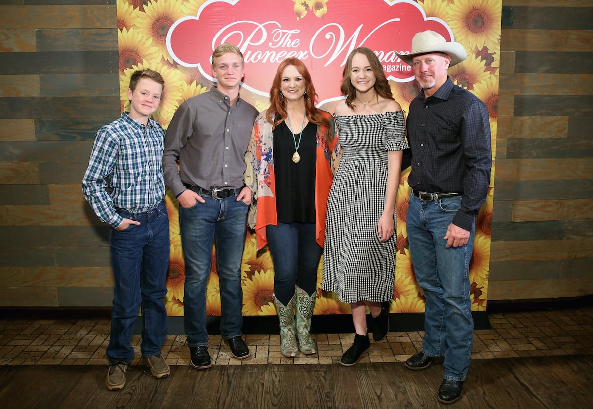 Ree Drummond wears a black top with a bright kimono and smiles with husband Ladd and their kids at a Pioneer Woman magazine event