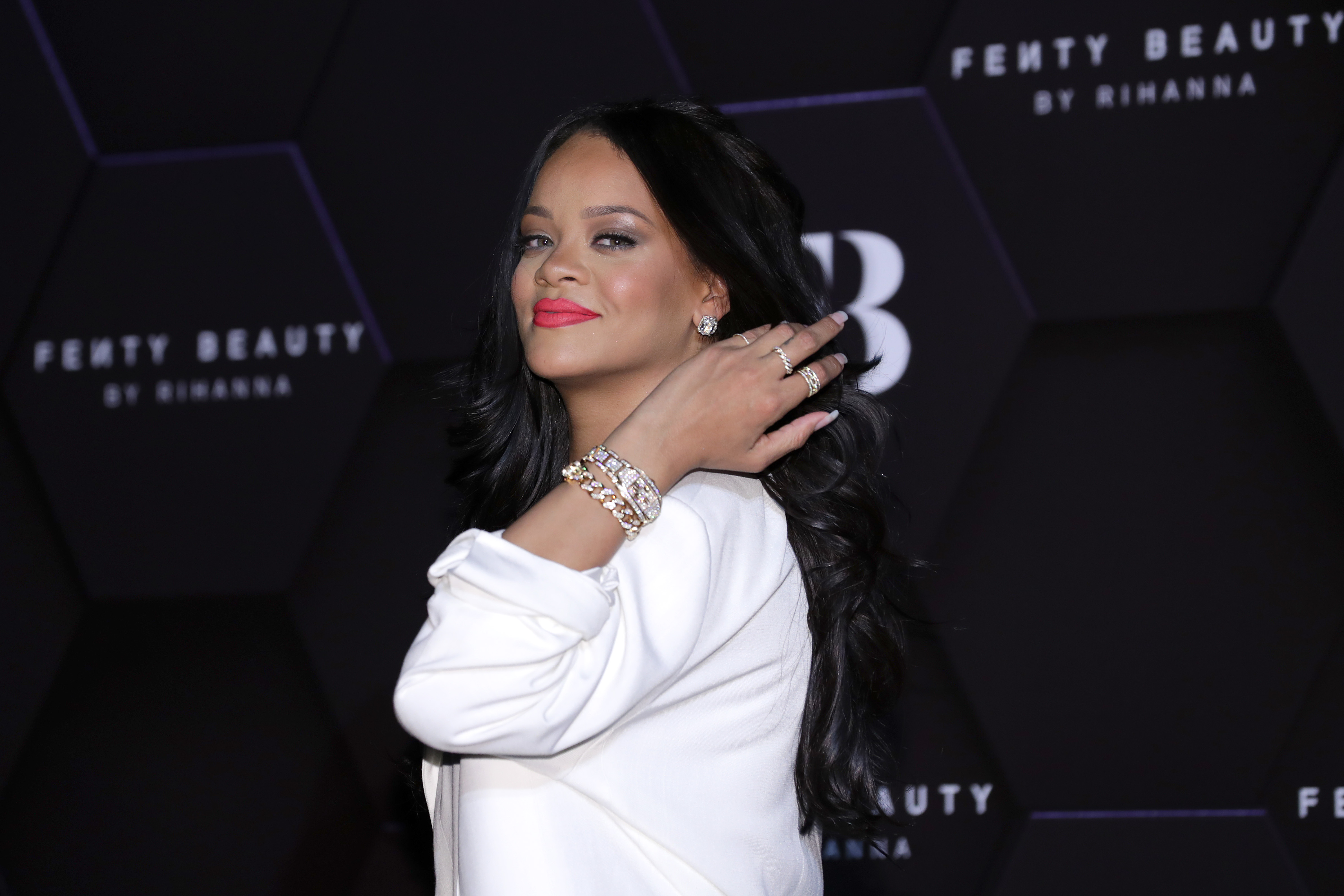 Rihanna wearing a white suit