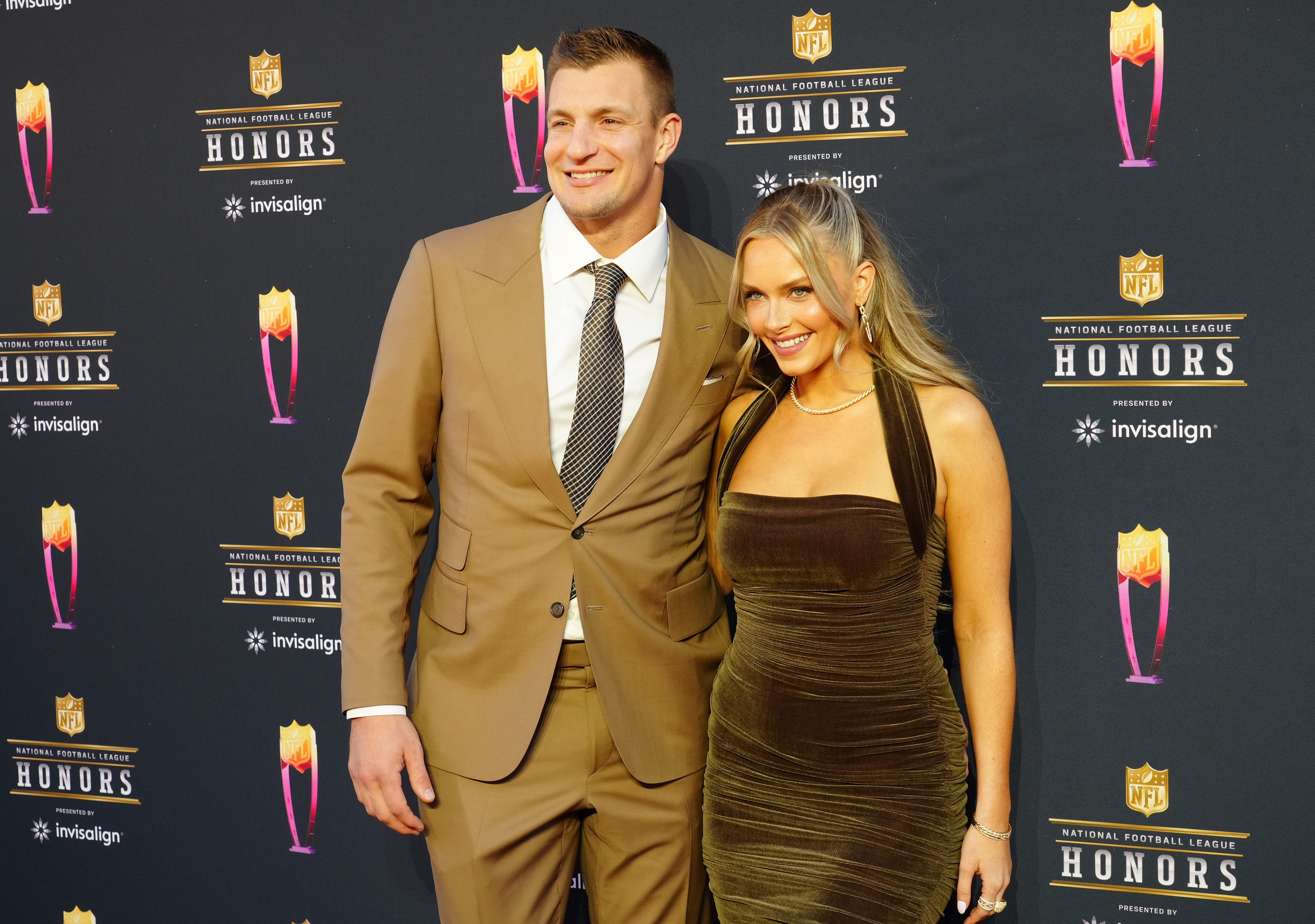 Rob Gronkowski and Camille Kostek pose for a photo on the red carpet at the 11th Annual NFL Honors
