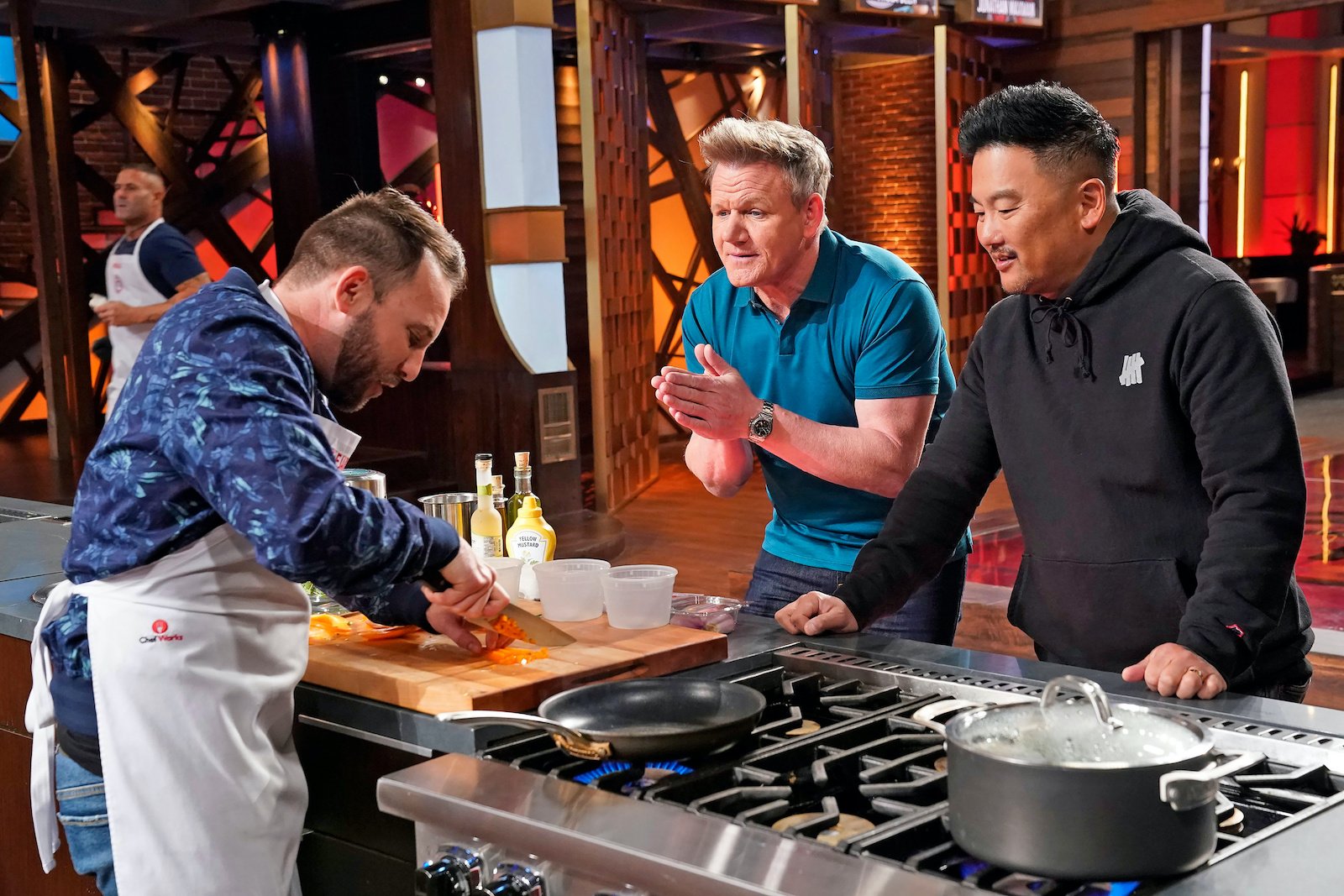 MasterChef contestant Alejandro cuts up a red pepper in front of chef Gordon Ramsay and chef Roy Choi
