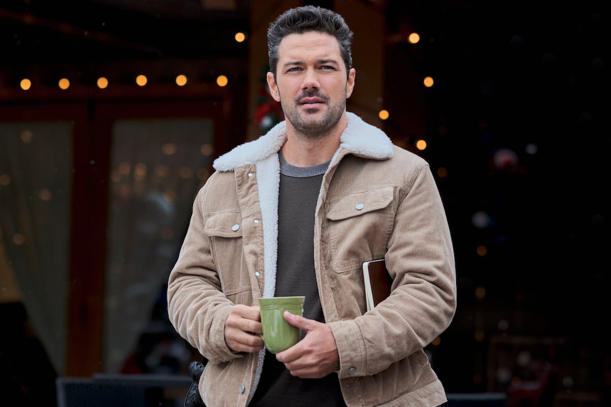 Ryan Paevey wearing a shearling jacket and holding a coffee mug in 'Coyote Creek Christmas'