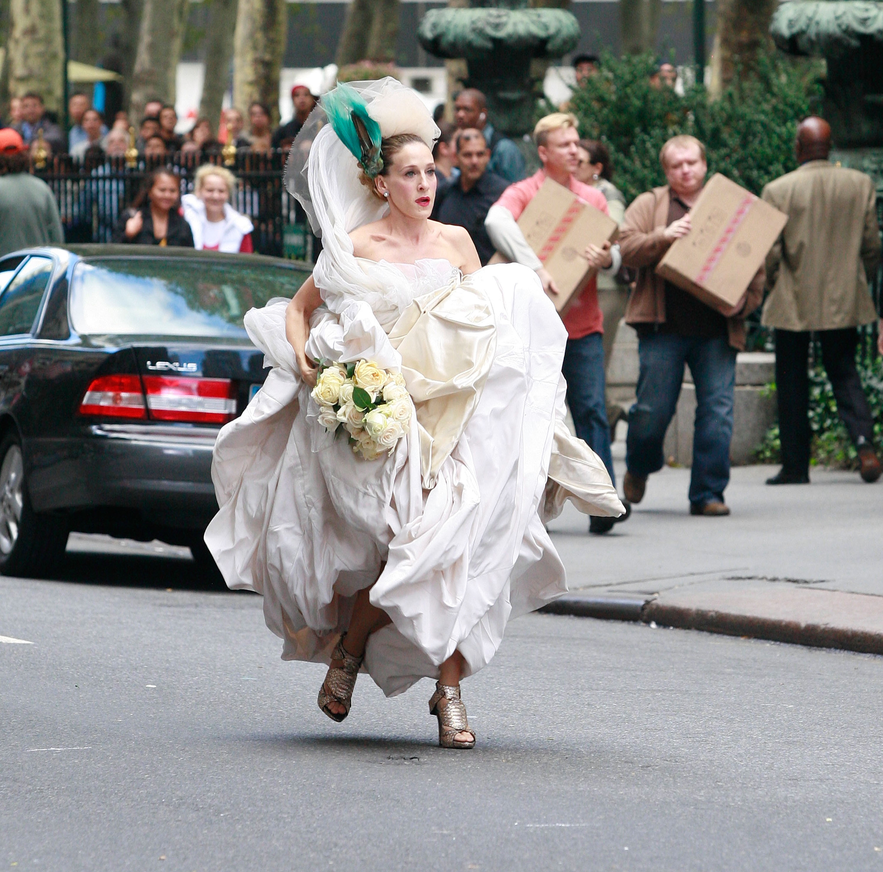 Sarah Jessica Parker is seen running down the street in her Vivienne Westwood wedding gown during the filming of 'Sex and the City: The Movie'