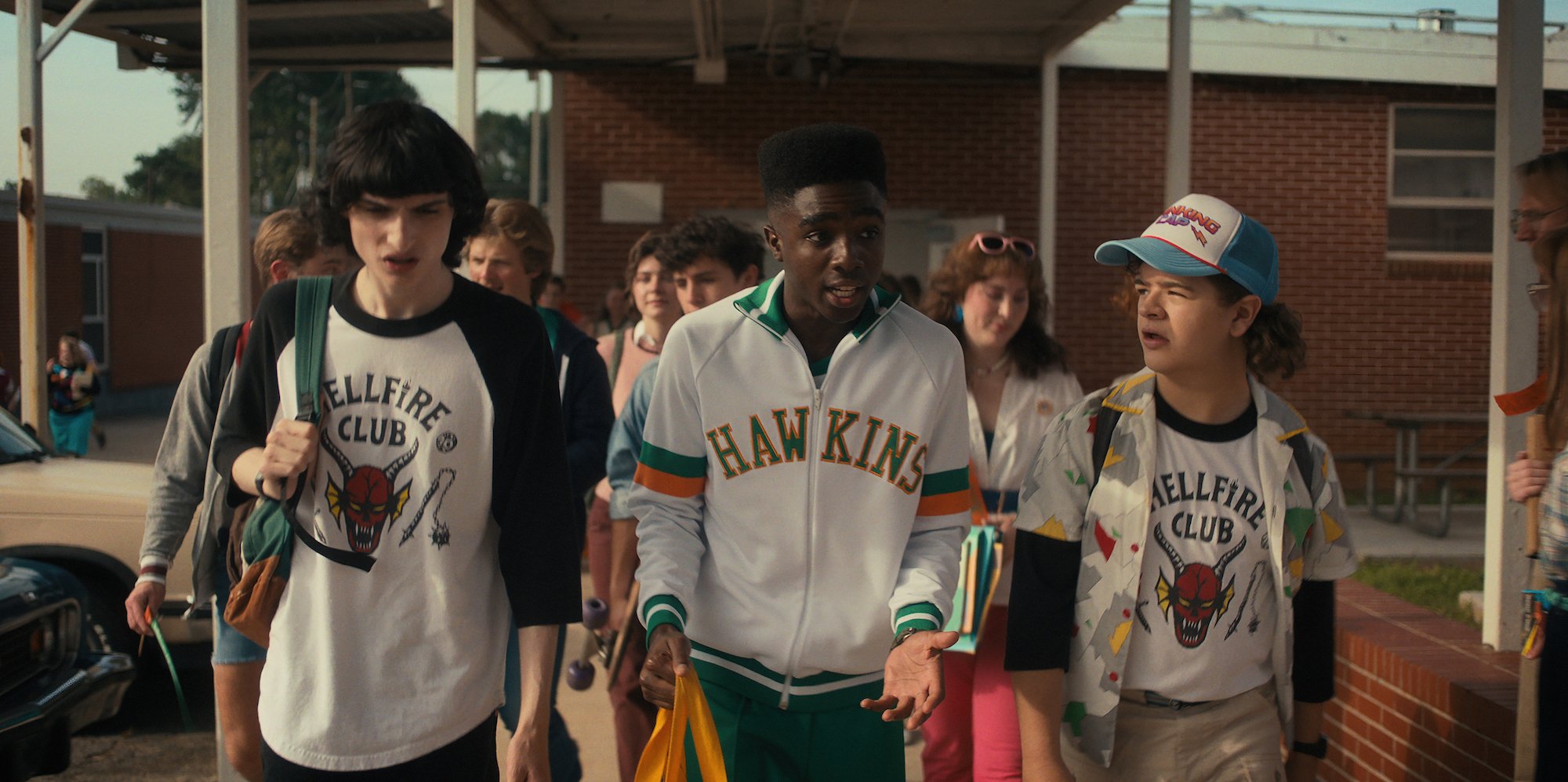 Mike, Lucas, and Dustin walk together at Hawkins High School.