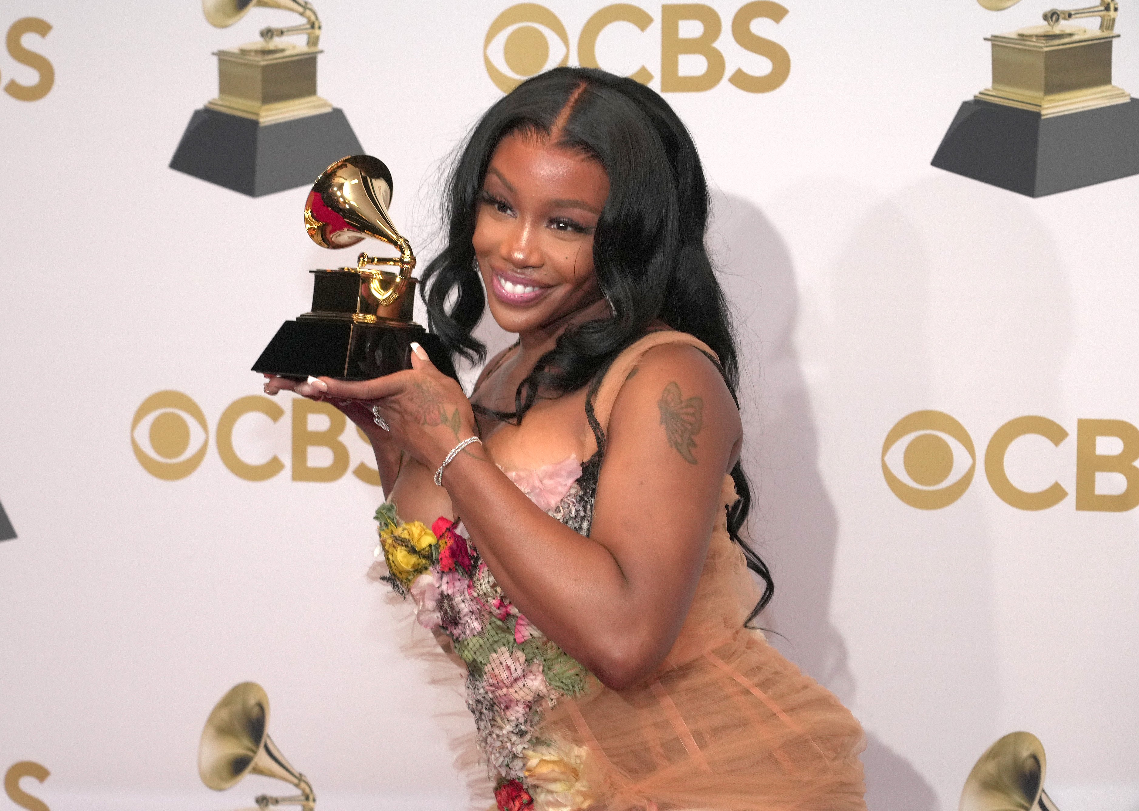 SZA poses with a Grammy Award in the winners photo room at the 2022 Grammy Awards