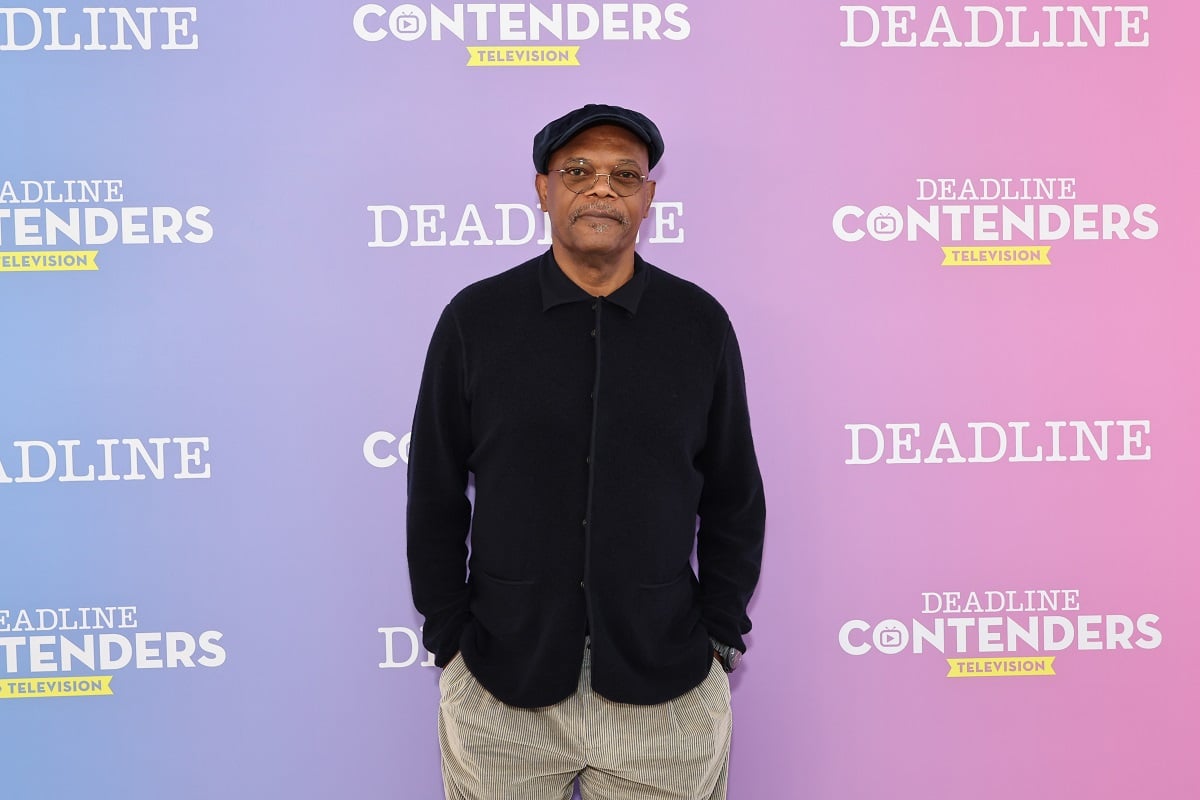 Samuel L Jackson posing while wearing a brown hat and glasses.