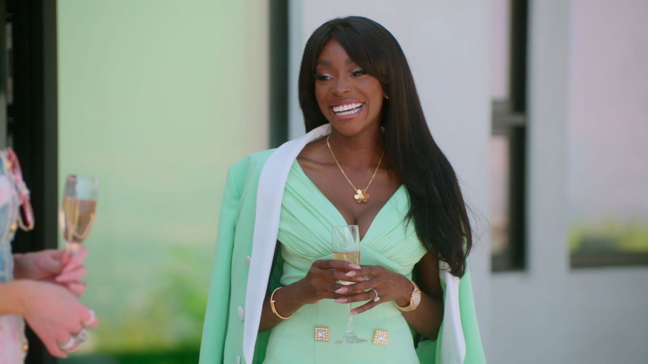 Chelsea Lazkani smiles in a mint jacket and dress in Selling Sunset.