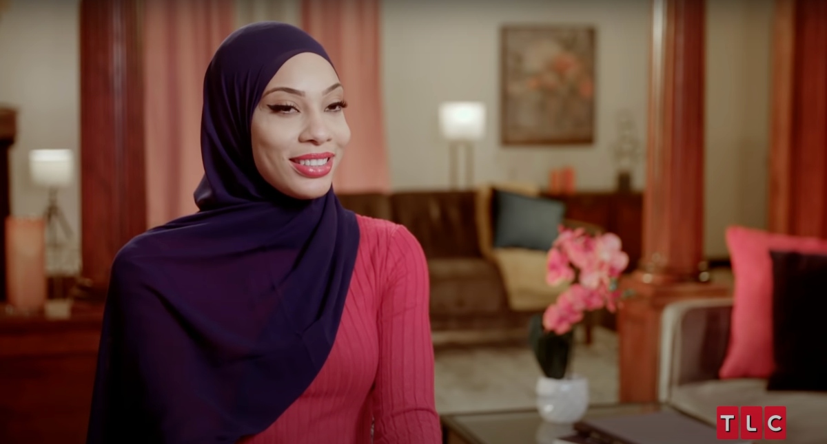 Shaeeda during a confessional, wearing a pink shirt and a black hijab on '90 Day Fiancé' Season 9.