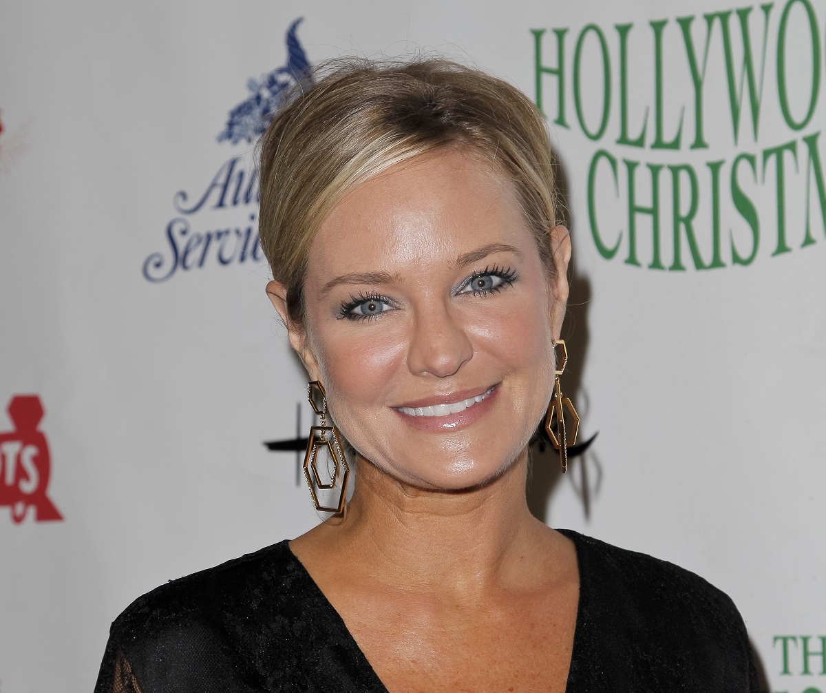 'The Young and the Restless' actor Sharon Case wearing a black dress and gold earrings.