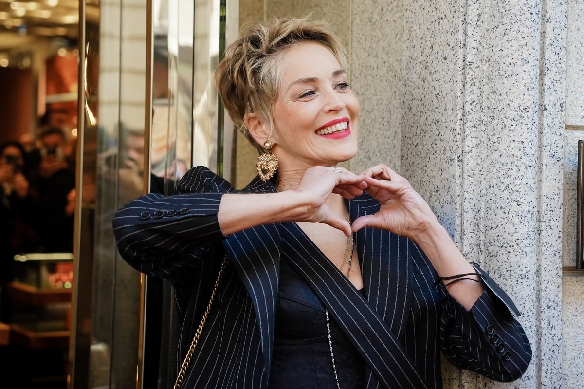 Sharon Stone, who has owned the same Los Angeles home for decades, making a heart gesture outside Dolce & Gabbana's boutique during Milan Fashion Week